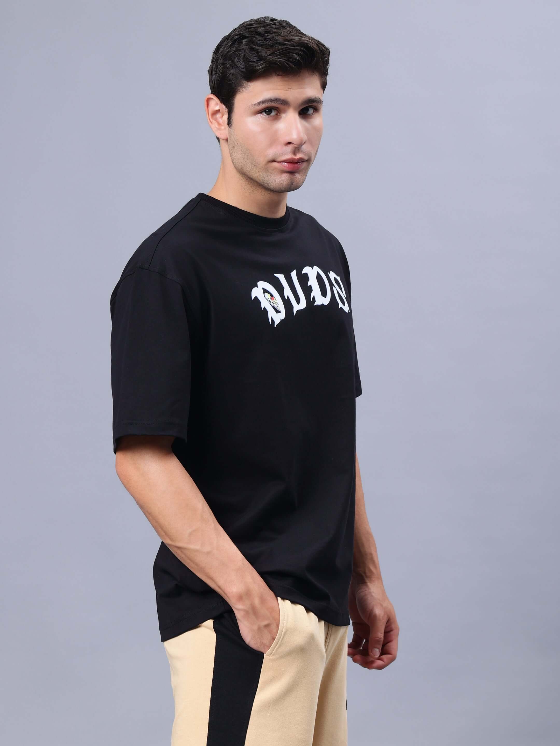 Male model wearing REBELS WTF OVER-SIZED T-SHIRT BLACK with custom fit option.