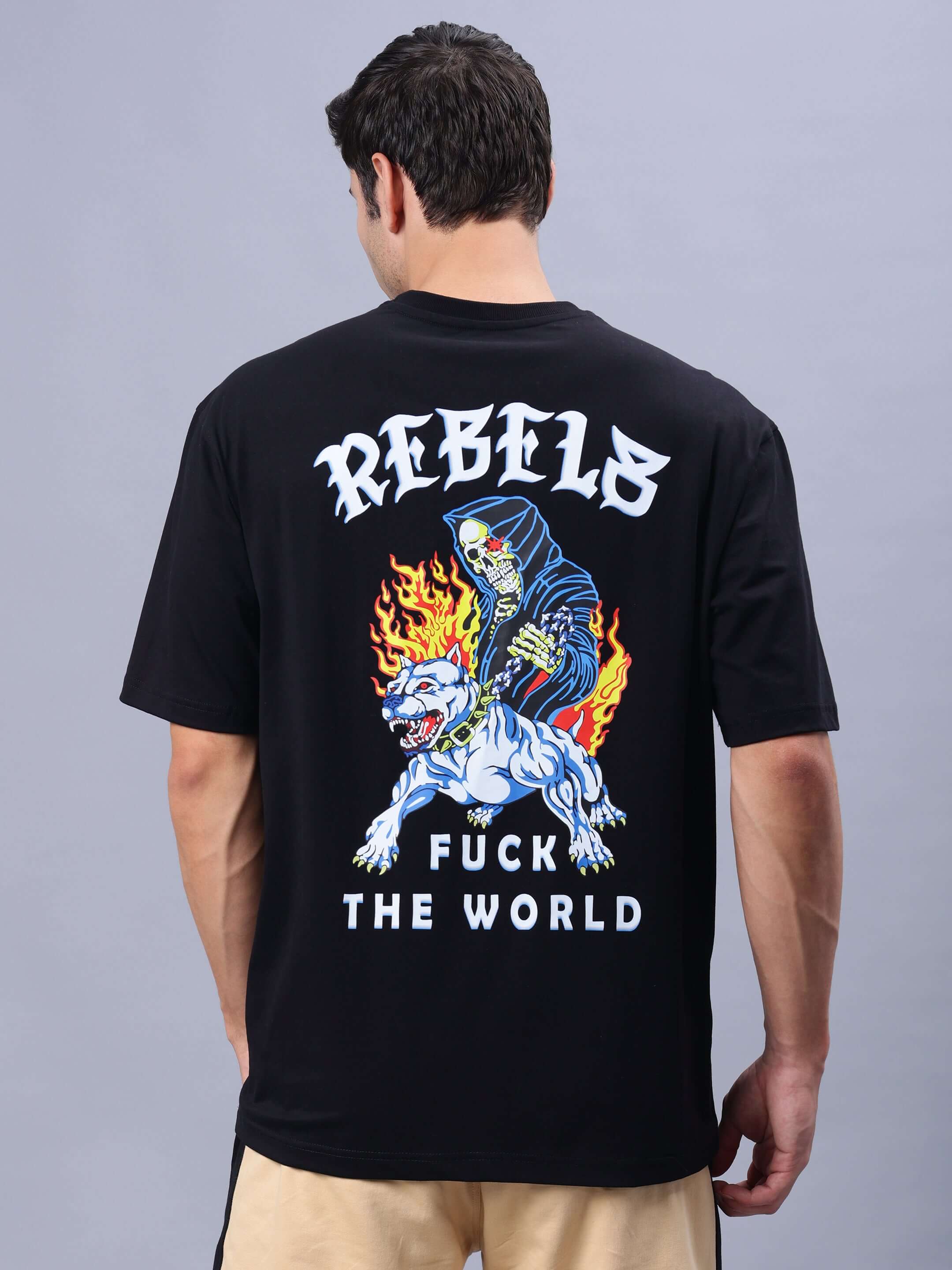 Person wearing REBELS WTF OVER-SIZED T-SHIRT BLACK with graphic design on the back.