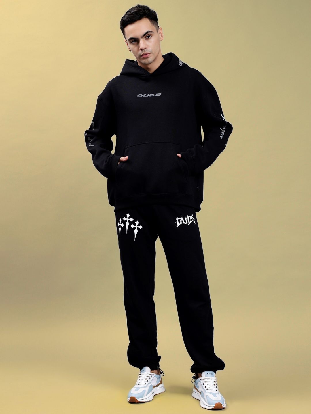 Model wearing POISON SKULL REFLECTOR OVERSIZE HOODIE BLACK, showcasing casual streetwear style against a simple background.