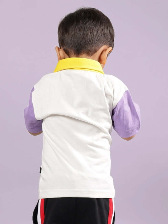 Child wearing off-white oversized T-shirt with purple sleeves and yellow collar, Borneo unisex design, made-to-order by DUDS