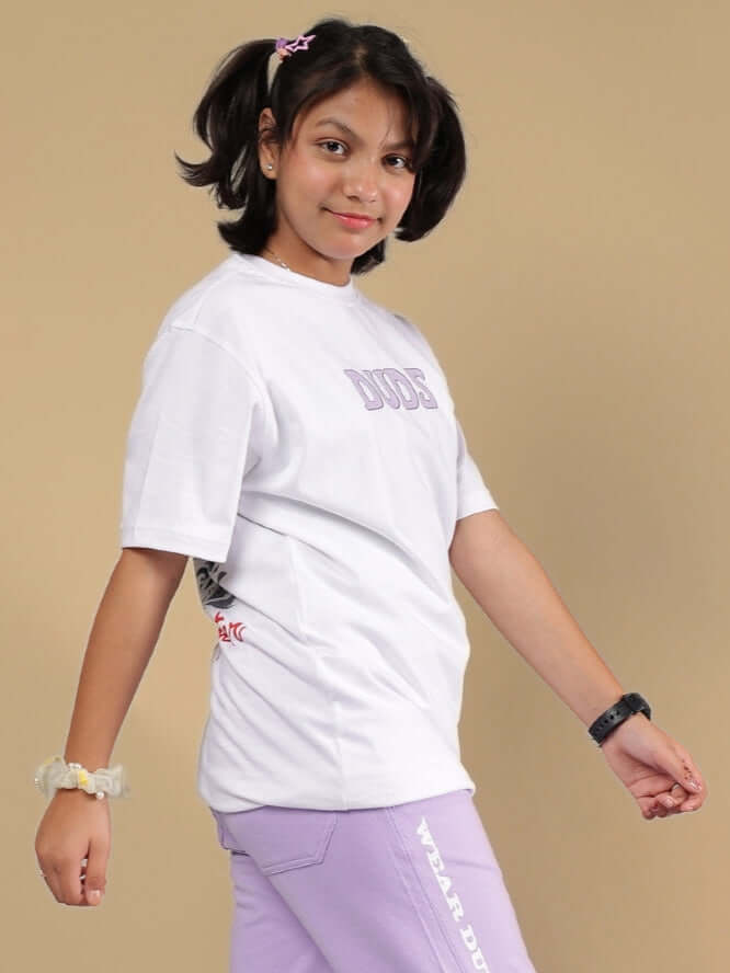 Young girl wearing a white Knight Ryder t-shirt by DUDS, styled for boys and girls. Comfortable, custom fit available. Made by expert tailors.
