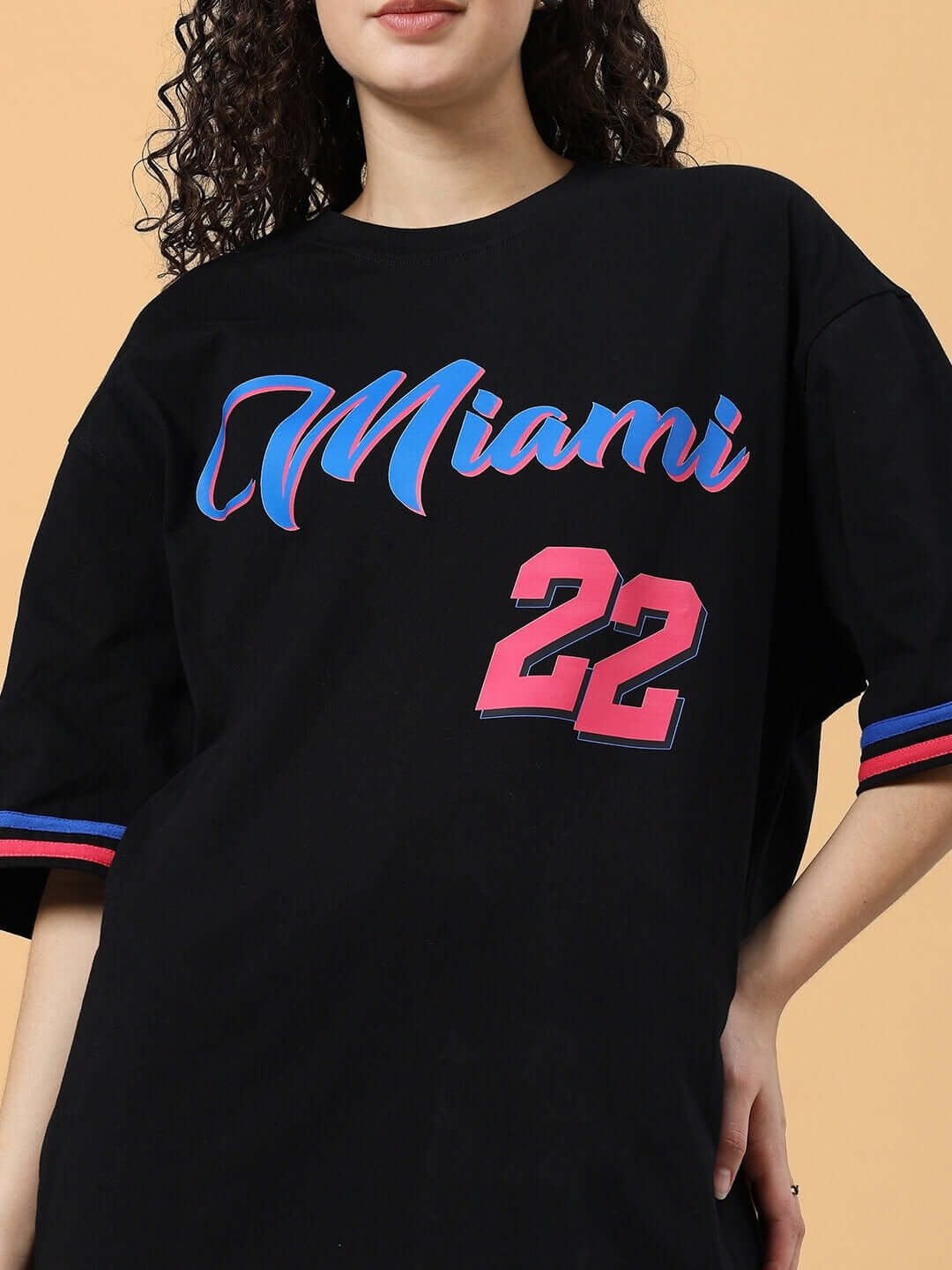 Women's oversized black Miami t-shirt in premium cotton with colorful design and comfortable fit. Perfect casual wear. Made in India.