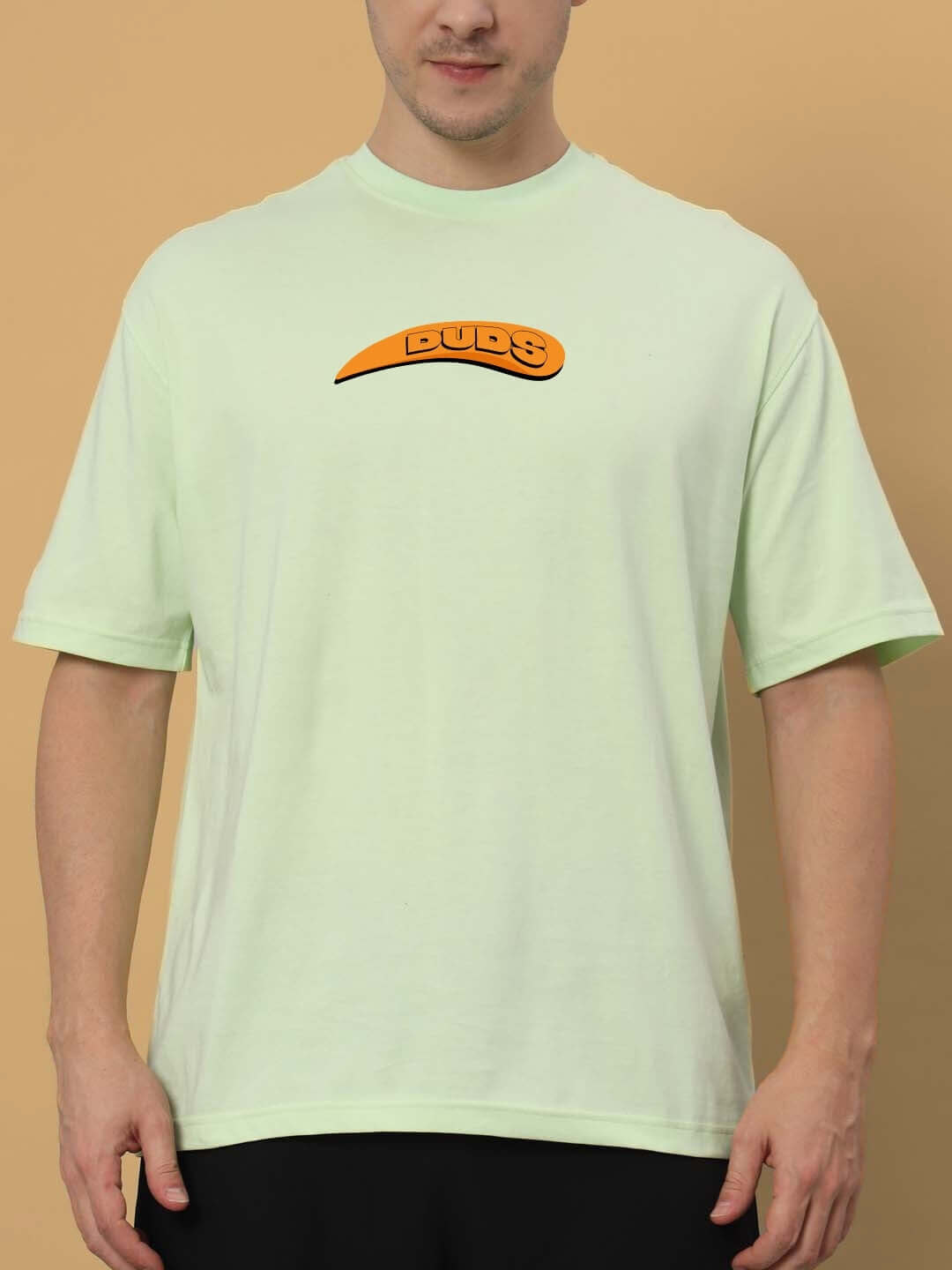 Man wearing GARFIELD OVER-SIZED T-SHIRT CELERY ICE with orange "Buds" logo, made of premium heavy gauge 100% cotton fabric.