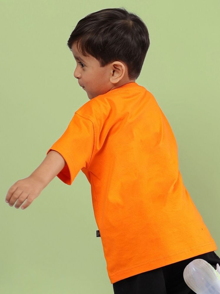 Child wearing vibrant orange Crazy Rapper t-shirt, showcasing hip-hop street fashion for kids.