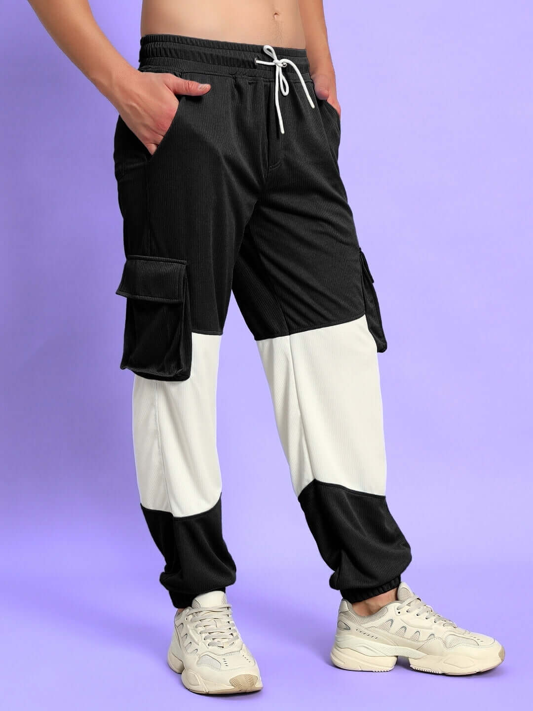 Model wearing Radiant Relaxed Fit Joggers in black and white with cargo pockets, perfect for comfort and style.