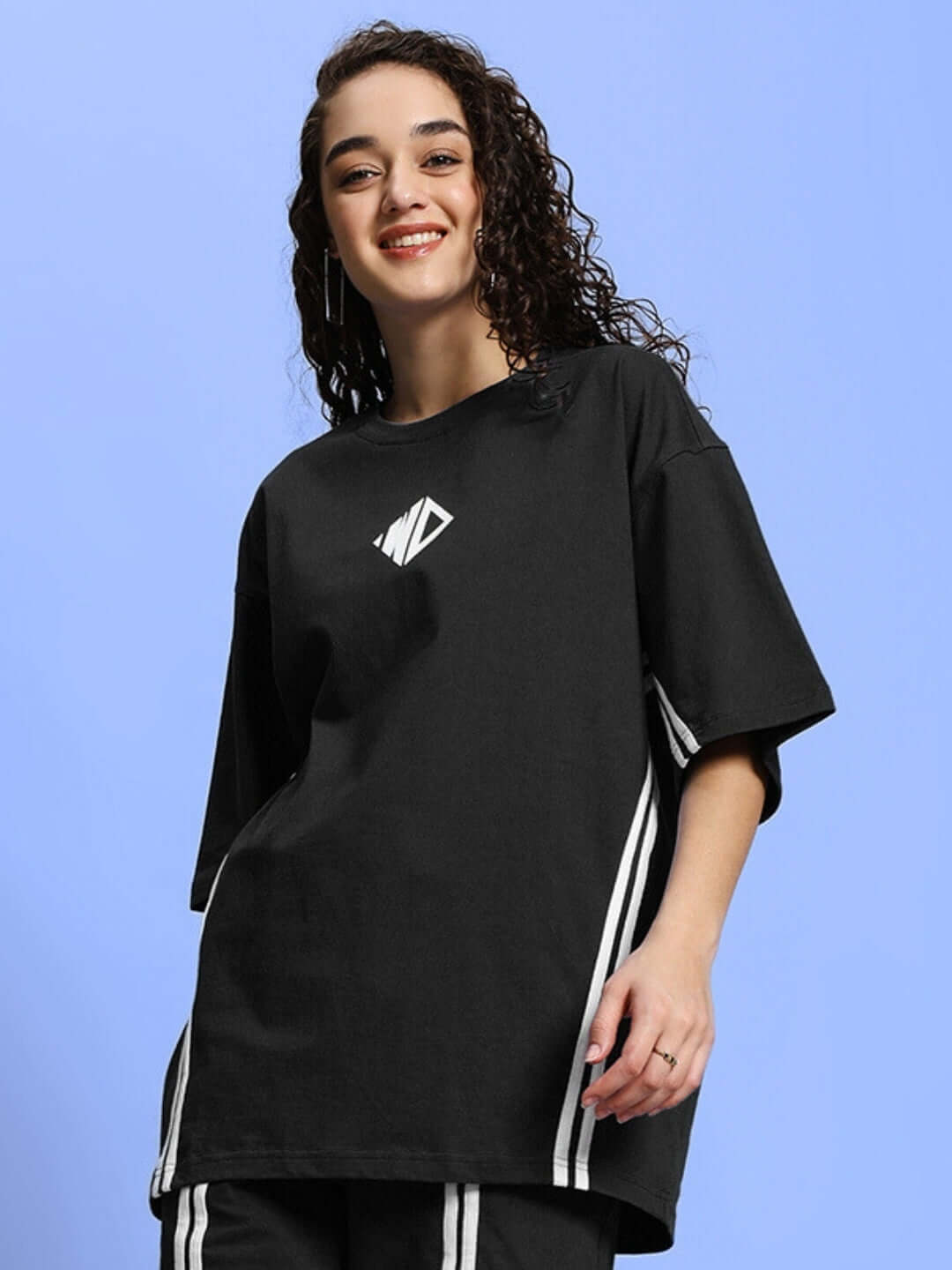 Black oversized women's t-shirt, premium cotton, French terry, featuring embroidered logo and white side stripes, styled casually.