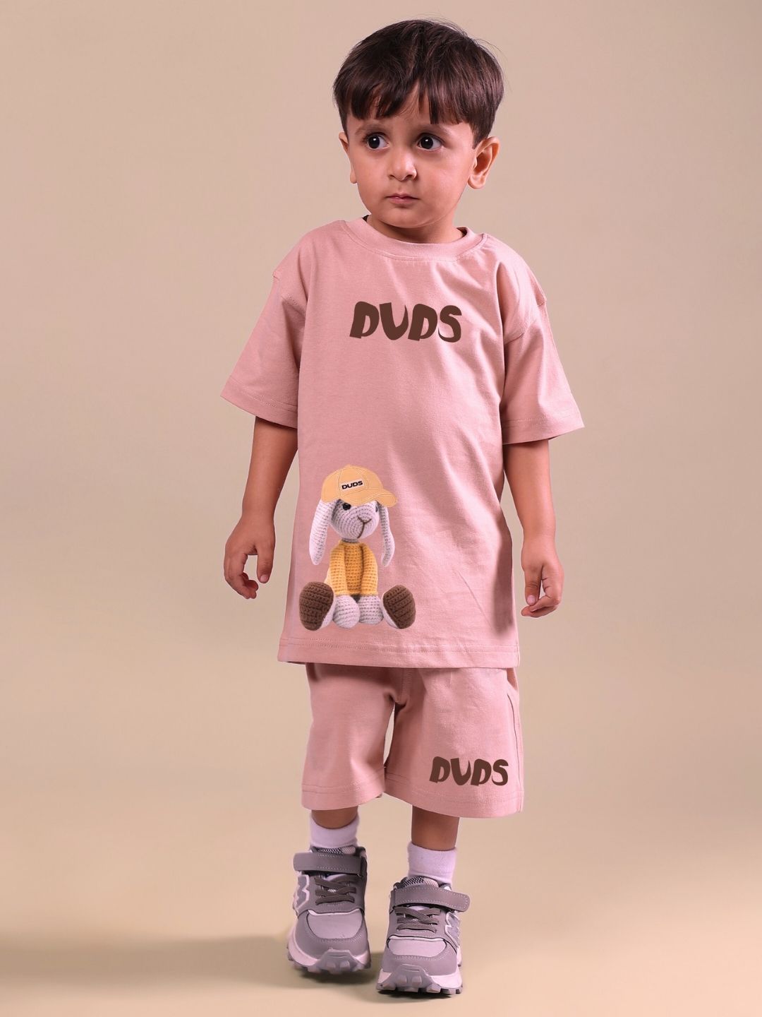 Toddler wearing a beige Flint Bunny co-ord set with bunny details, suitable for boys and girls.