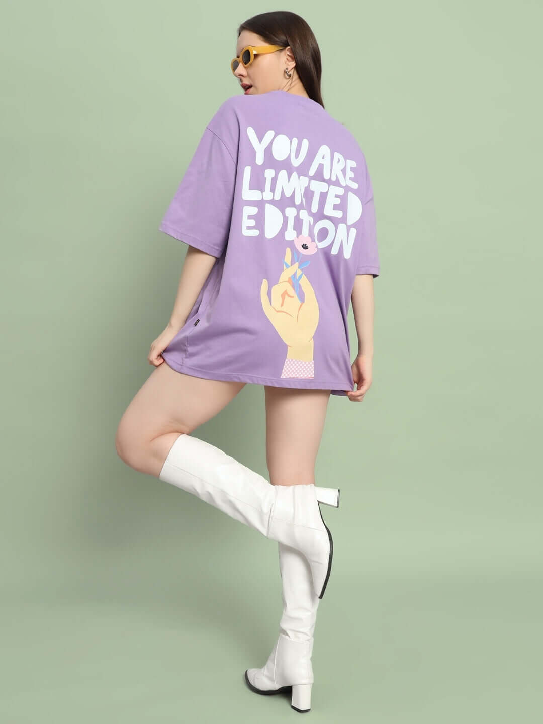 Model wearing women's limited edition oversized lavender t-shirt with "You Are Limited Edition" print, custom fit option available.