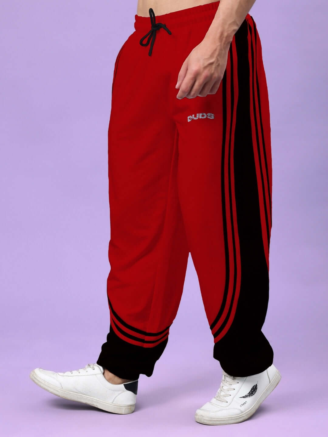 Model wearing red and black Frenzy Curve Contrast Joggers with DUDS branding.