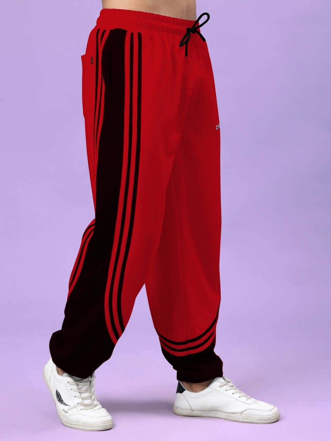 Red and black Frenzy Curve Contrast Joggers by DUDS, featuring bold side stripes, perfect for a custom fit and made-to-order fashion.