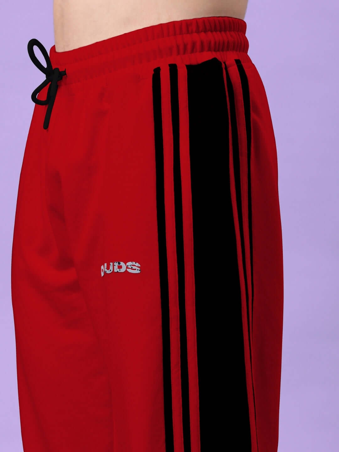 Red and black contrast joggers by DUDS featuring a side stripe design, showcasing comfortable fit and stylish look.