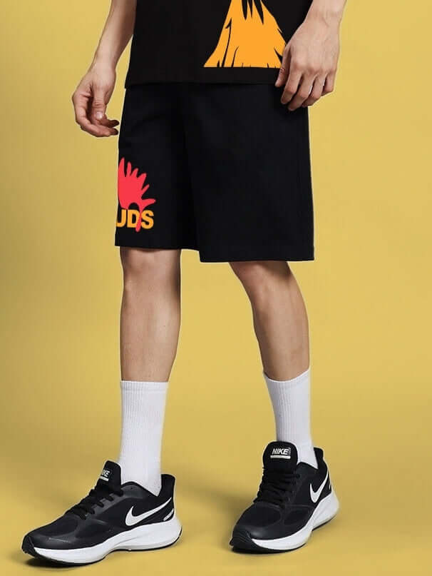 Black funny chicken summer shorts with DUDS logo, worn by model, customizable fit available, shown with white socks and black sneakers.