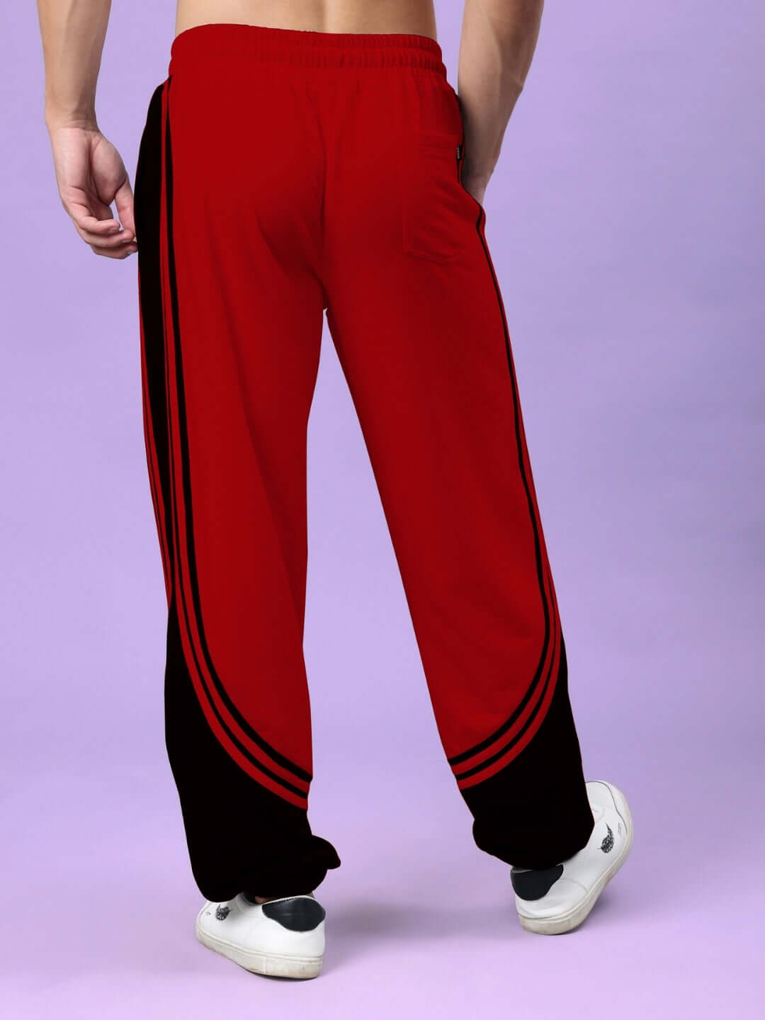 Man wearing Frenzy Curve Contrast Joggers in red and black from DUDS, showcasing unique design and comfort.
