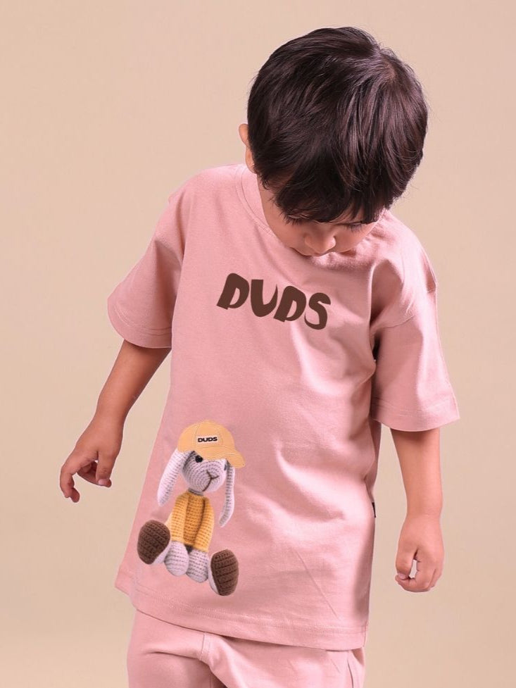 Child wearing a beige unisex Flint Bunny t-shirt featuring a cute bunny graphic, ideal for boys and girls who love animals.