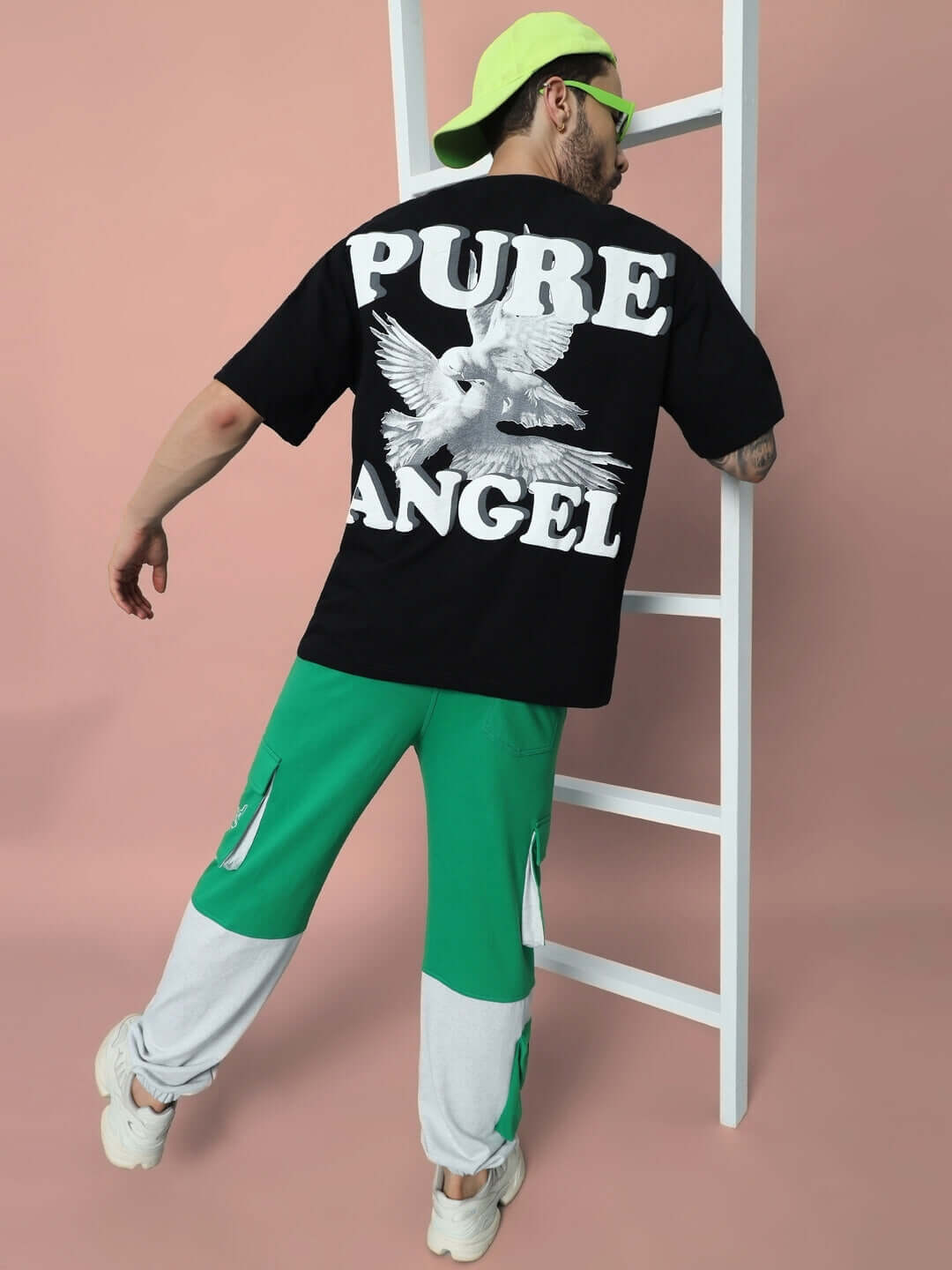 Model wearing SKYSCRAPER RELAXED FIT CARGO PANT GREEN with a black graphic tee and neon accessories