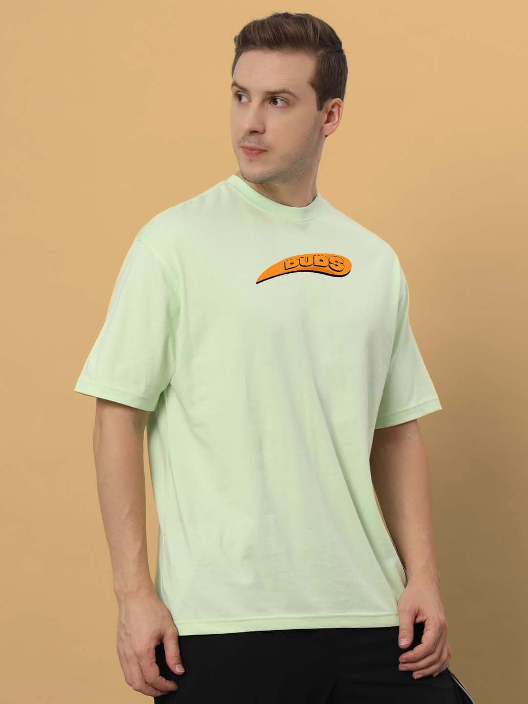 Man wearing GARFIELD OVER-SIZED T-SHIRT CELERY ICE, 100% cotton, premium heavy gauge fabric, bio-washed, in light green color.
