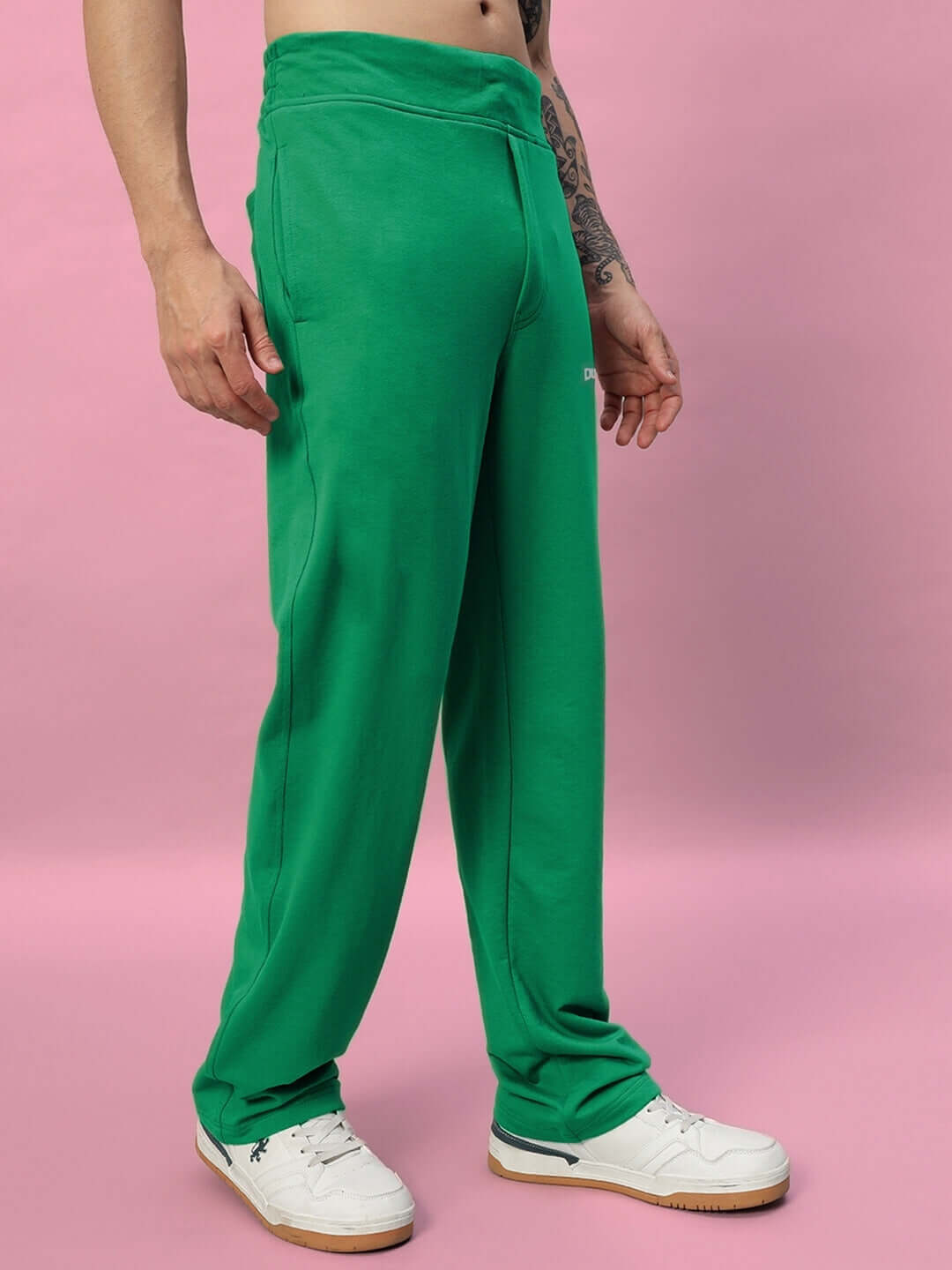 Model wearing New Era Relaxed Fit Joggers in green, showcasing comfortable and stylish design, available for custom fit at DUDS.