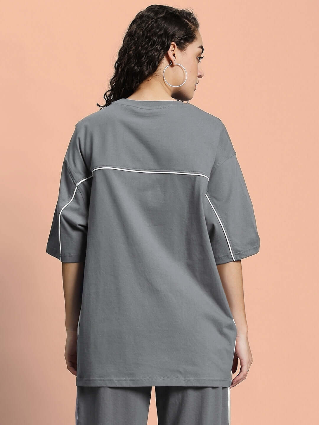 Back view of model wearing Women's Indy Oversized Classic Grey T-shirt, featuring premium cotton blend material.
