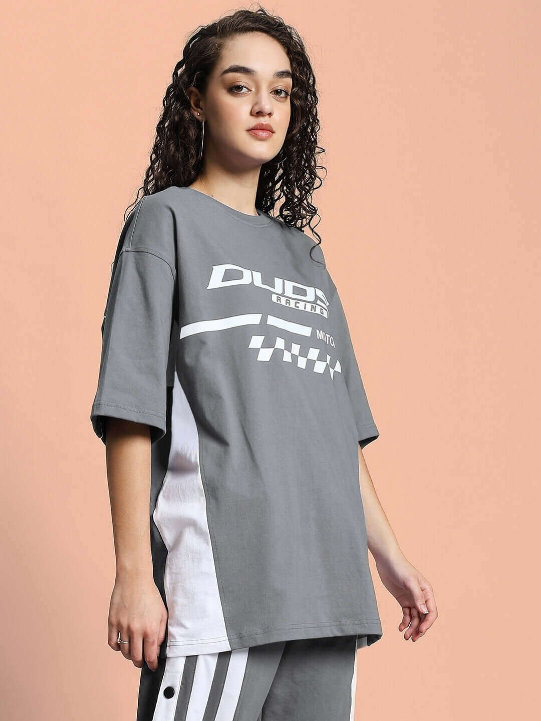 Model wearing Women's Indy Over-Sized Classic T-Shirt in grey, featuring premium cotton fabric with a relaxed fit, side view.