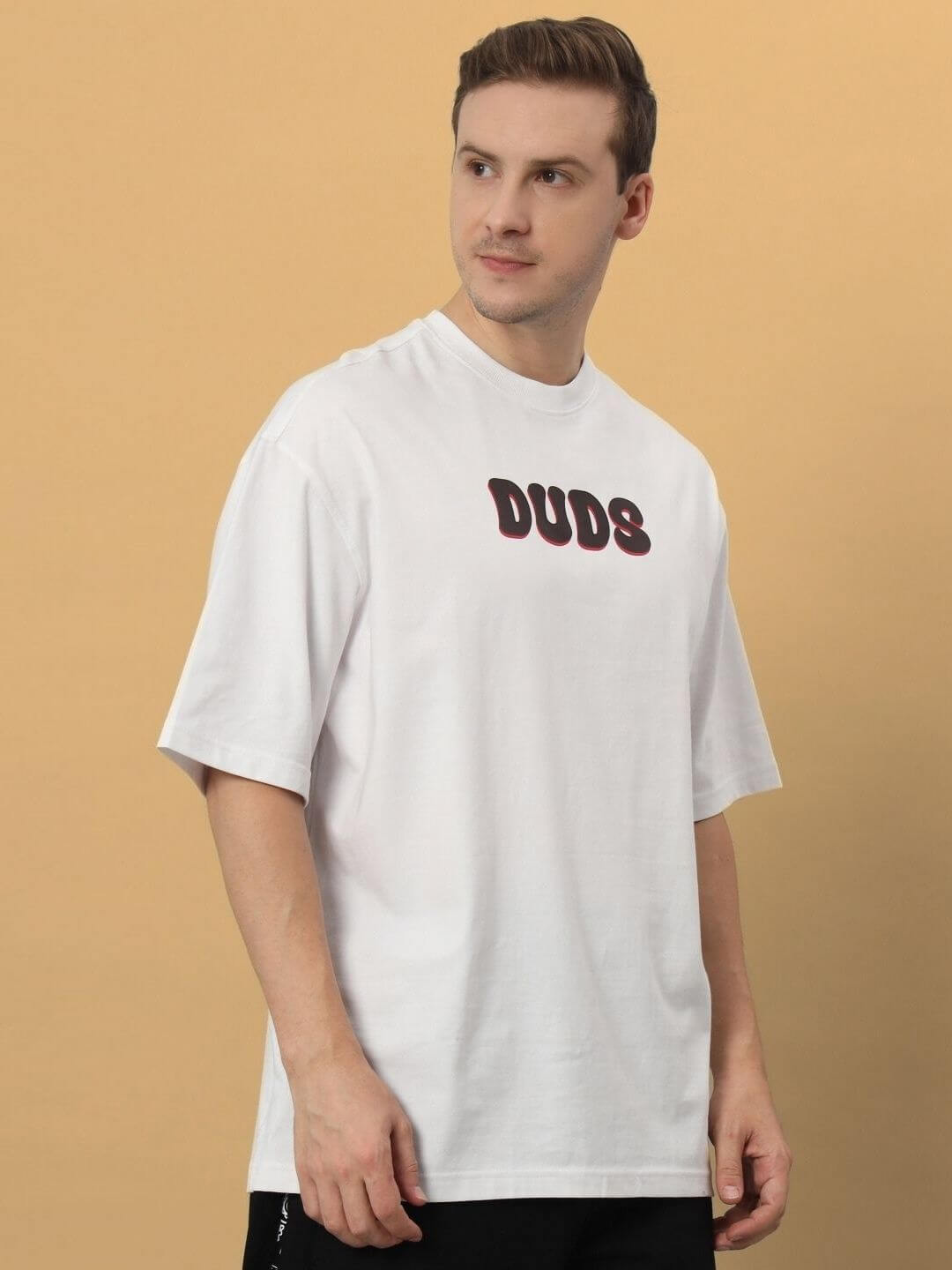 Person wearing a CARINO OVER-SIZED T-SHIRT WHITE, made from premium heavy gauge fabric, 100% cotton, 200 GSM bio-washed.