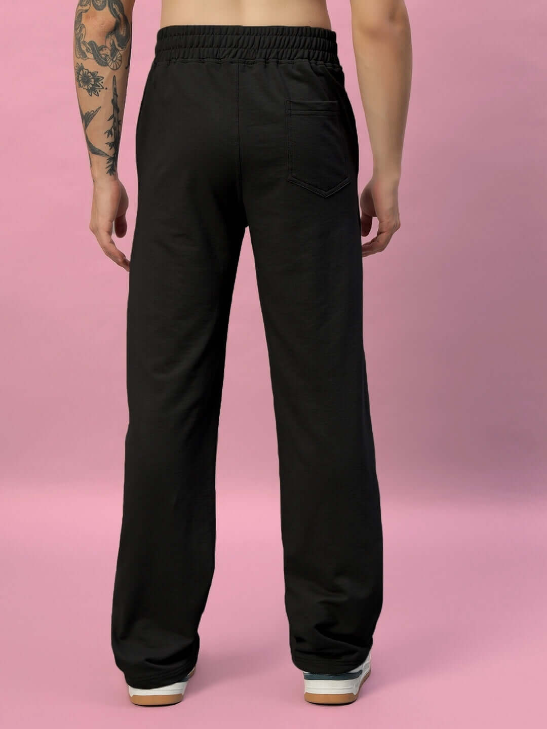 Model wearing New Era Relaxed Fit Black Joggers, showcasing back design, made by experienced tailors, available for custom fit.