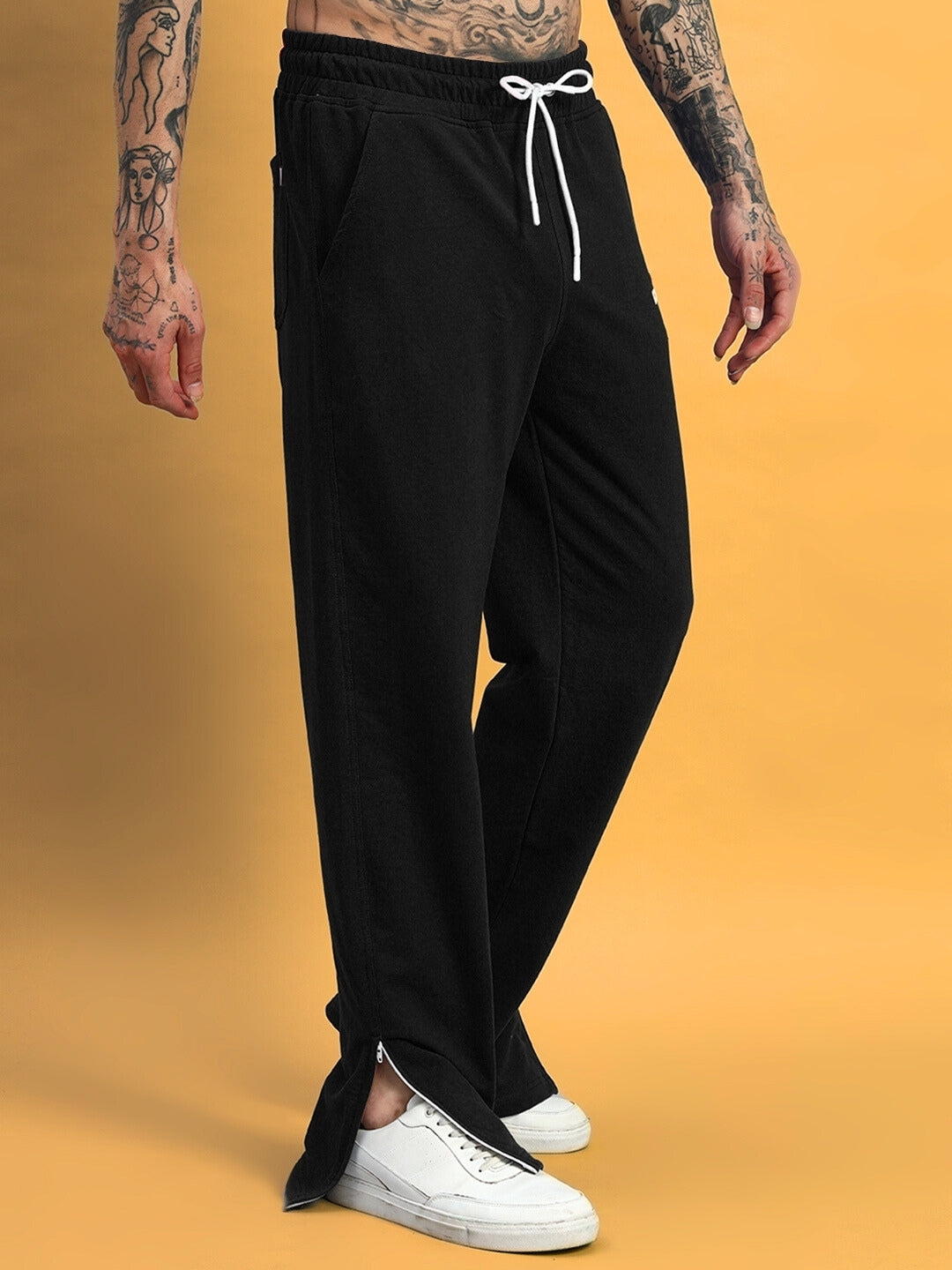 Black Hershey Side Slit Joggers shown with elastic waist and ankle-length fit, paired with white sneakers. Made-to-order by DUDS.