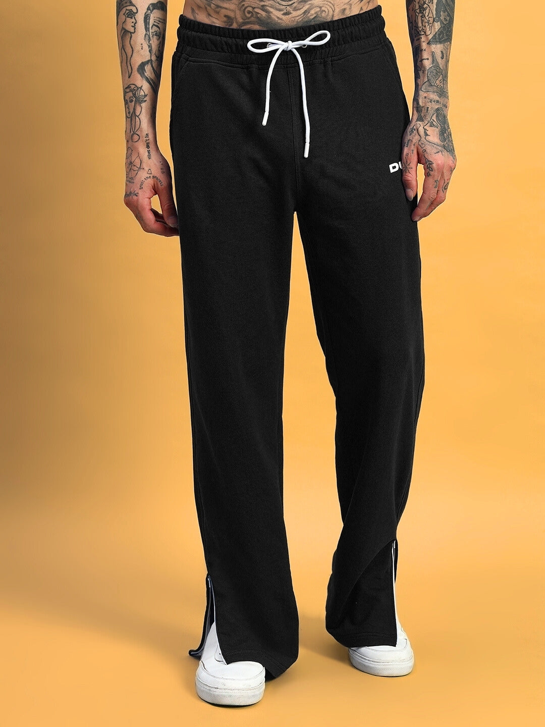 Black Hershey side slit joggers by DUDS with custom fit option, featuring white drawstring and casual style against a yellow background.