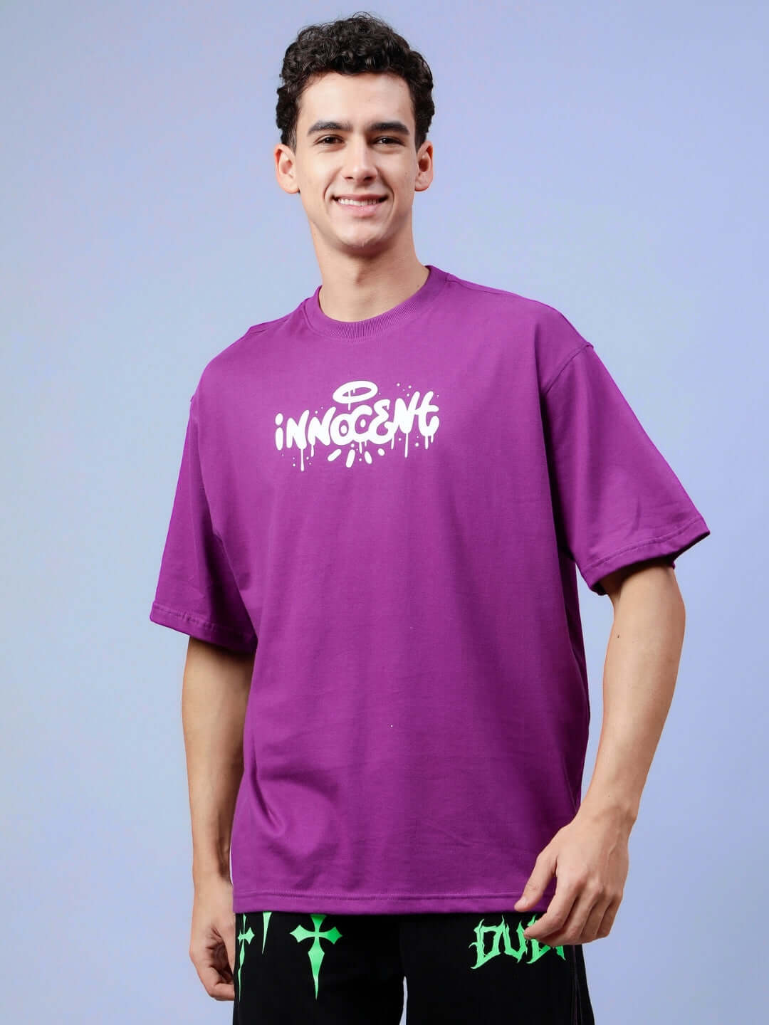 INNOCENT OVER-SIZED T-SHIRT PURPLE worn by a model against a blue background