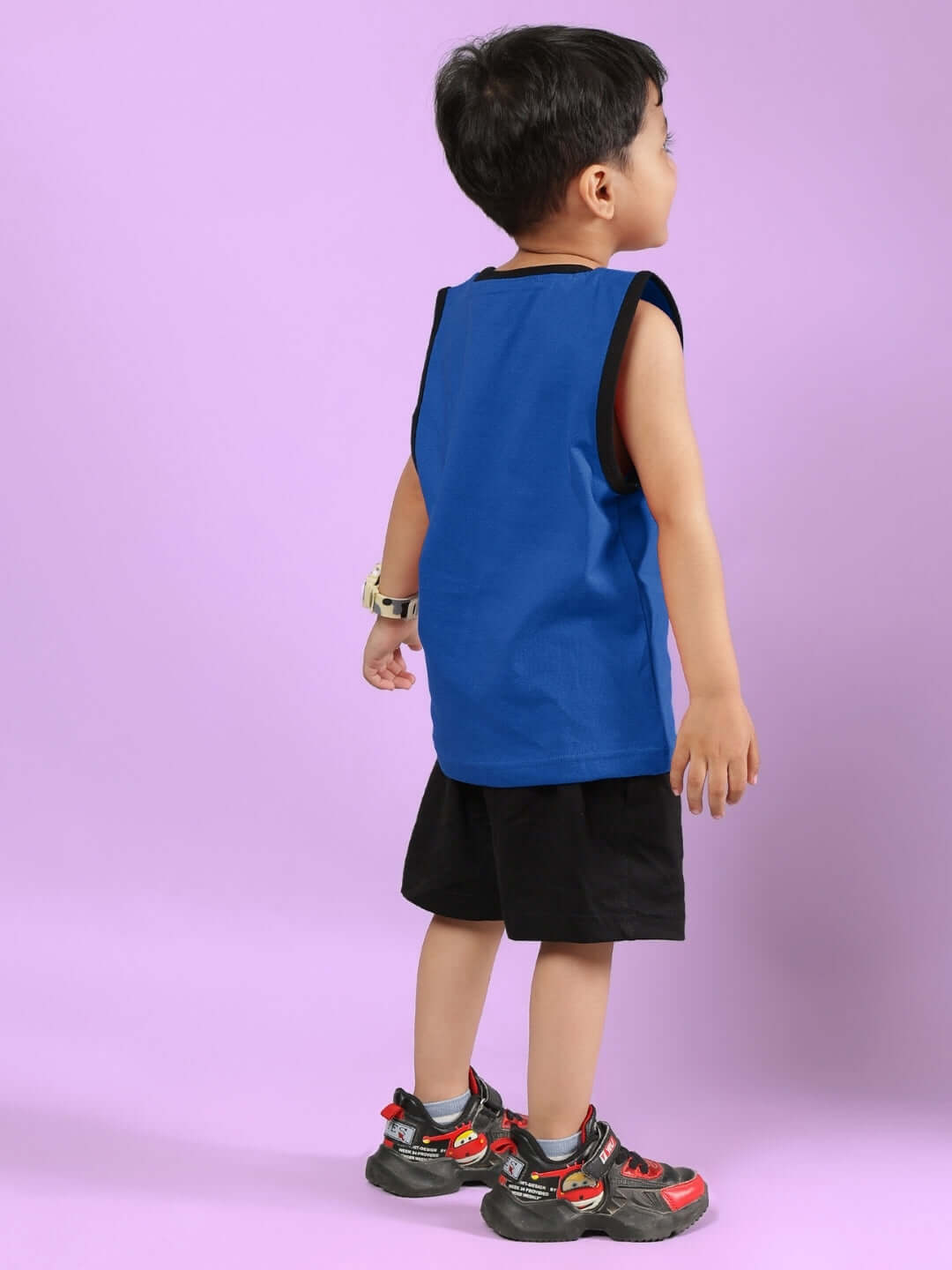 Young child wearing the AMIGA blue and black co-ord set by DUDS, featuring a sleeveless top and shorts, perfect for boys and girls.