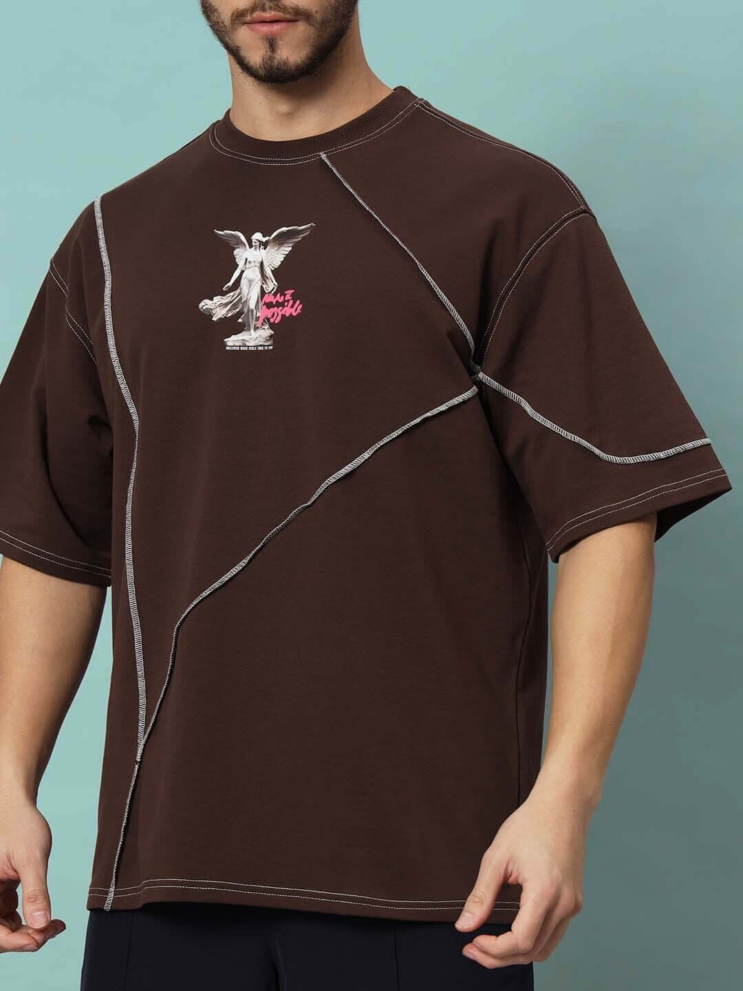 MAKE IT POSSIBLE CONTRAST STITCHED OVER-SIZED T-SHIRT BROWN with angel graphic and premium fabric blend shown on model.