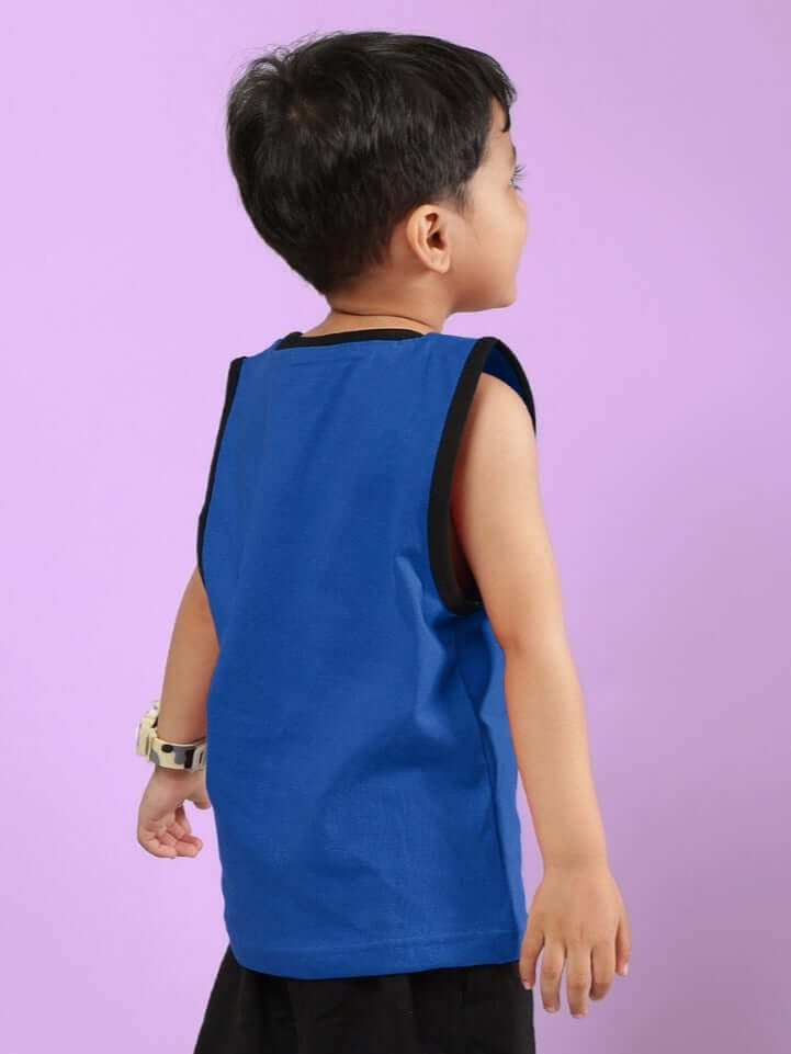 Child wearing a blue AMIGA T-shirt, suitable for boys and girls, showcasing back view with a vibrant purple background.