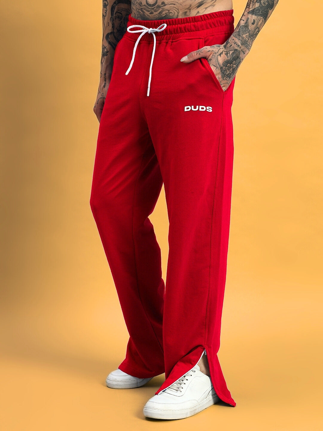 Model wearing red Hershey Side Slit Joggers by DUDS, featuring a relaxed fit and customizable size options.
