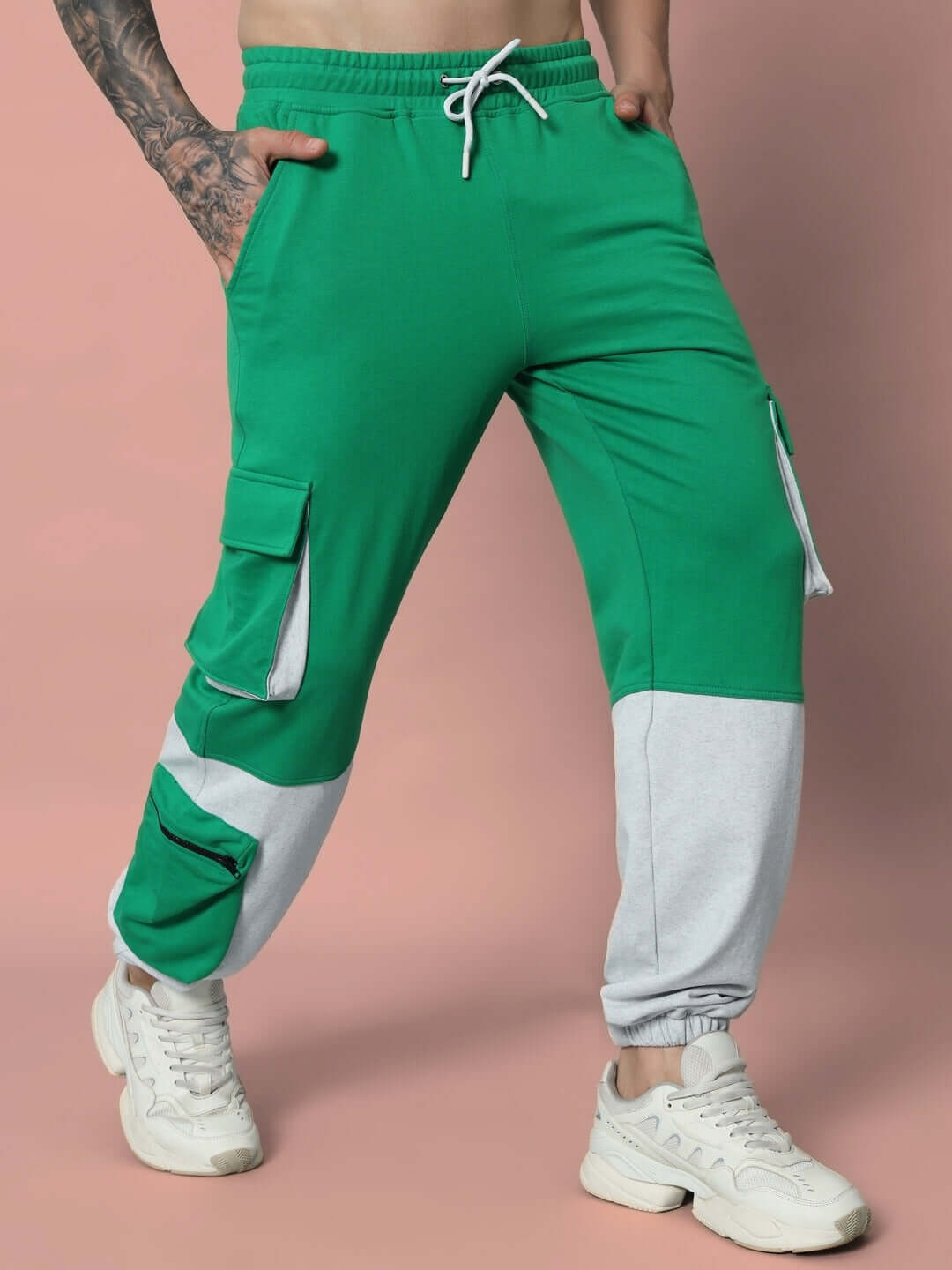 Model wearing SKYSCRAPER RELAXED FIT CARGO PANT GREEN with pockets and drawstring waist.