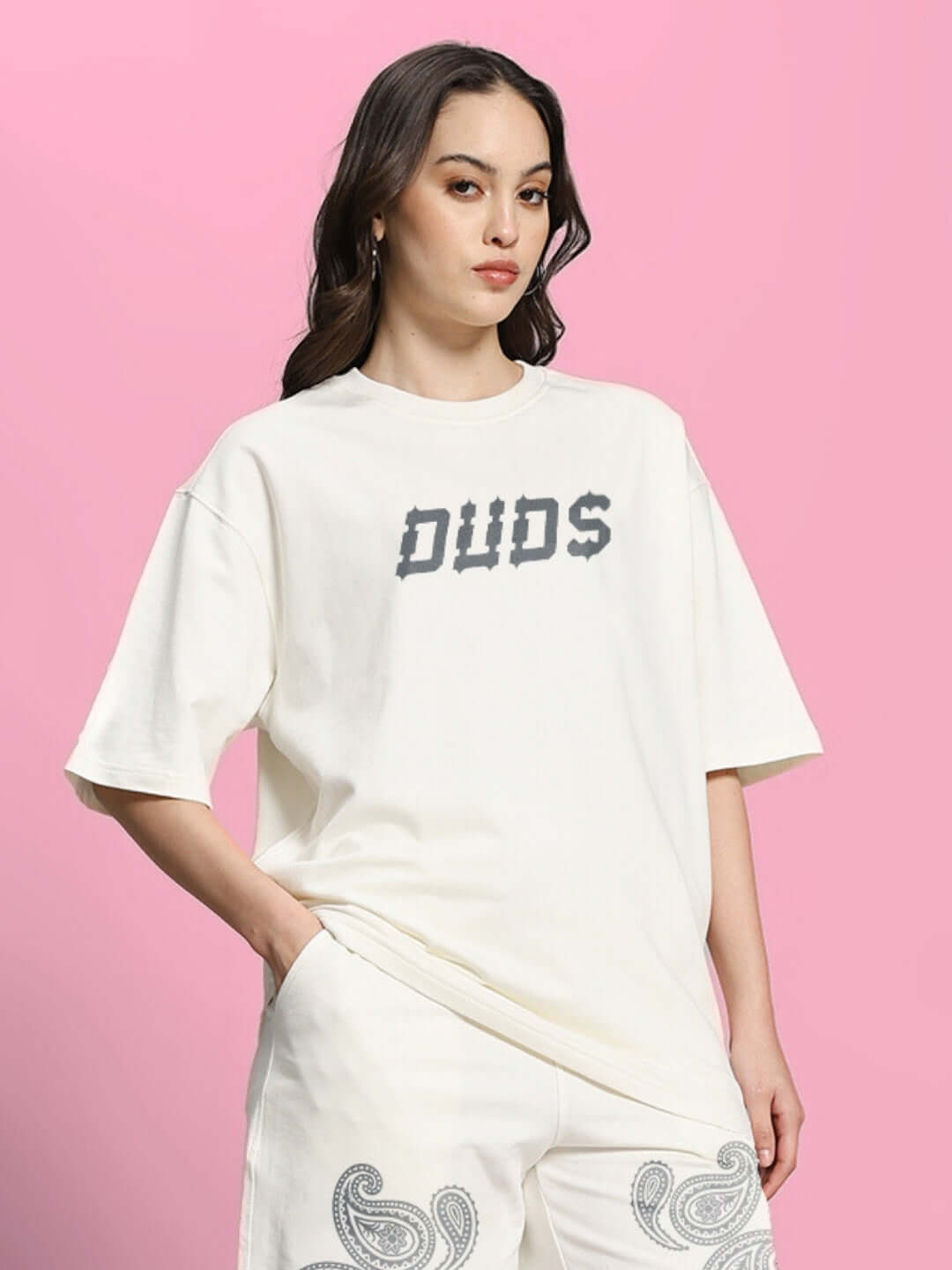 Alt Tag: Woman wearing an oversized off-white t-shirt with paisley print design from Color By Colours, made of premium cotton blend.