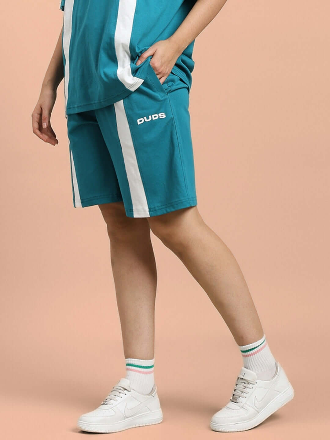 Teal women's wideline regular fit shorts by Duds, featuring a white stripe design, customizable fit option available, styled with white sneakers.