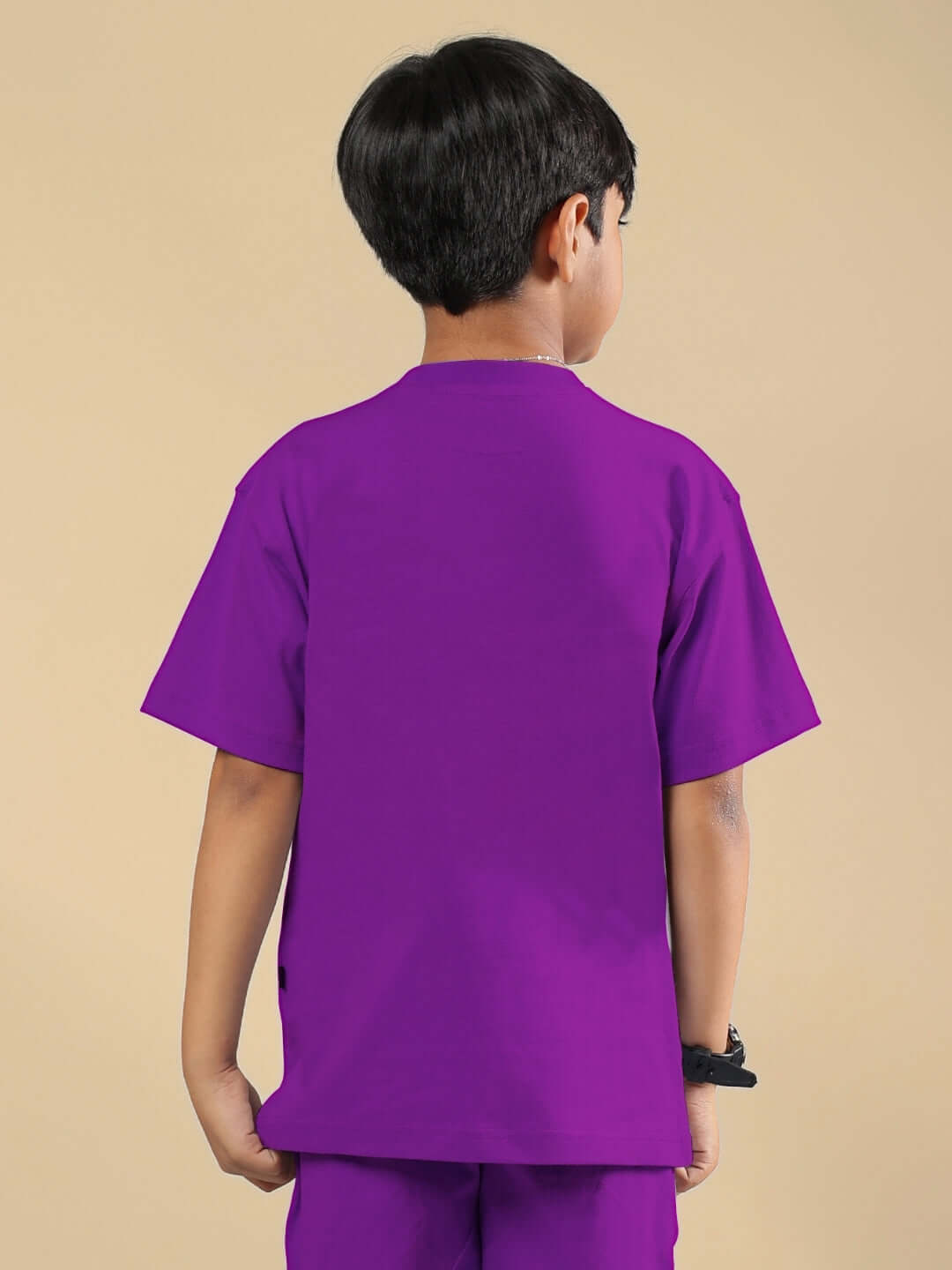 Back view of child wearing AUTHENTIC RIDER T-SHIRT for boys and girls in purple, made to order by DUDS, showcasing vibrant color and fit.