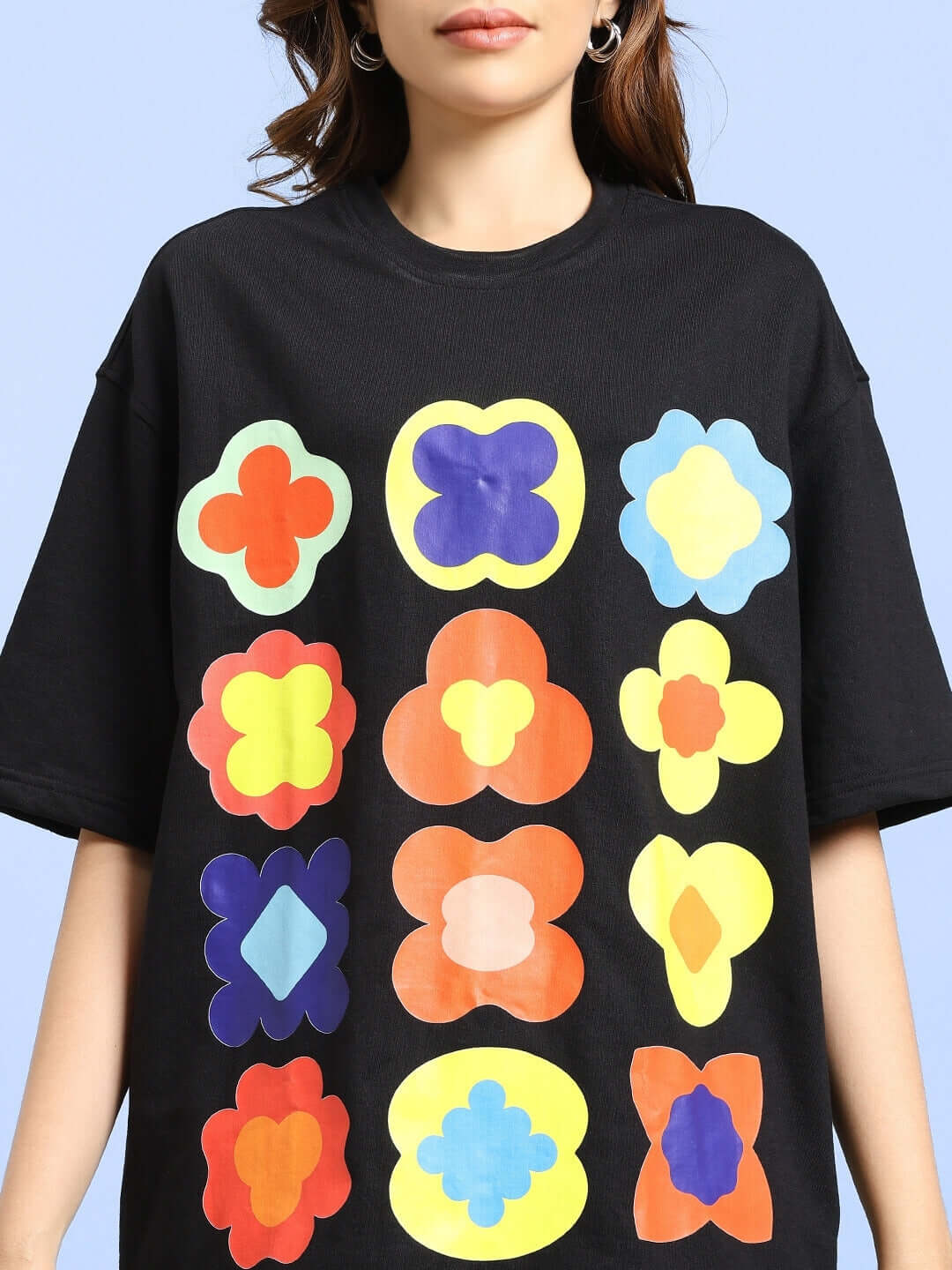 Women's Hollister black oversized T-shirt with colorful geometric designs, made of premium cotton and elastane blend, shown on a model.