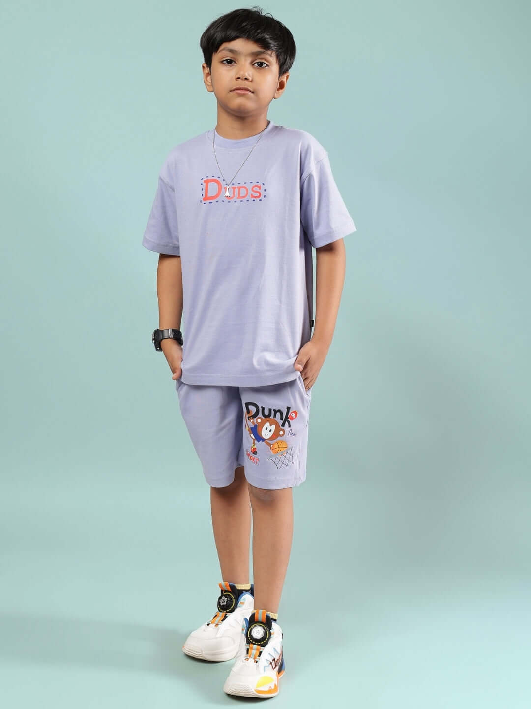 Child wearing lavender SAMMY Co-ord set by DUDS, featuring a t-shirt and shorts. Made to order for boys and girls. Custom fit available.