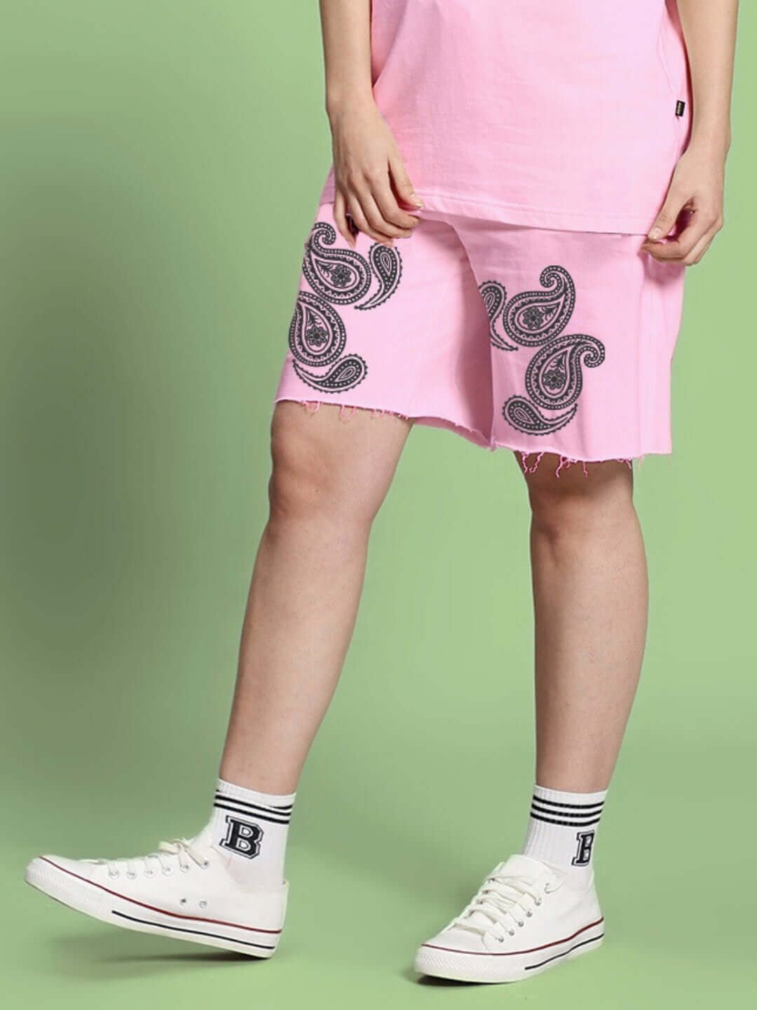 Pink paisley print women's shorts with regular fit, showcasing casual style and unique design, worn with white sneakers for a trendy look.