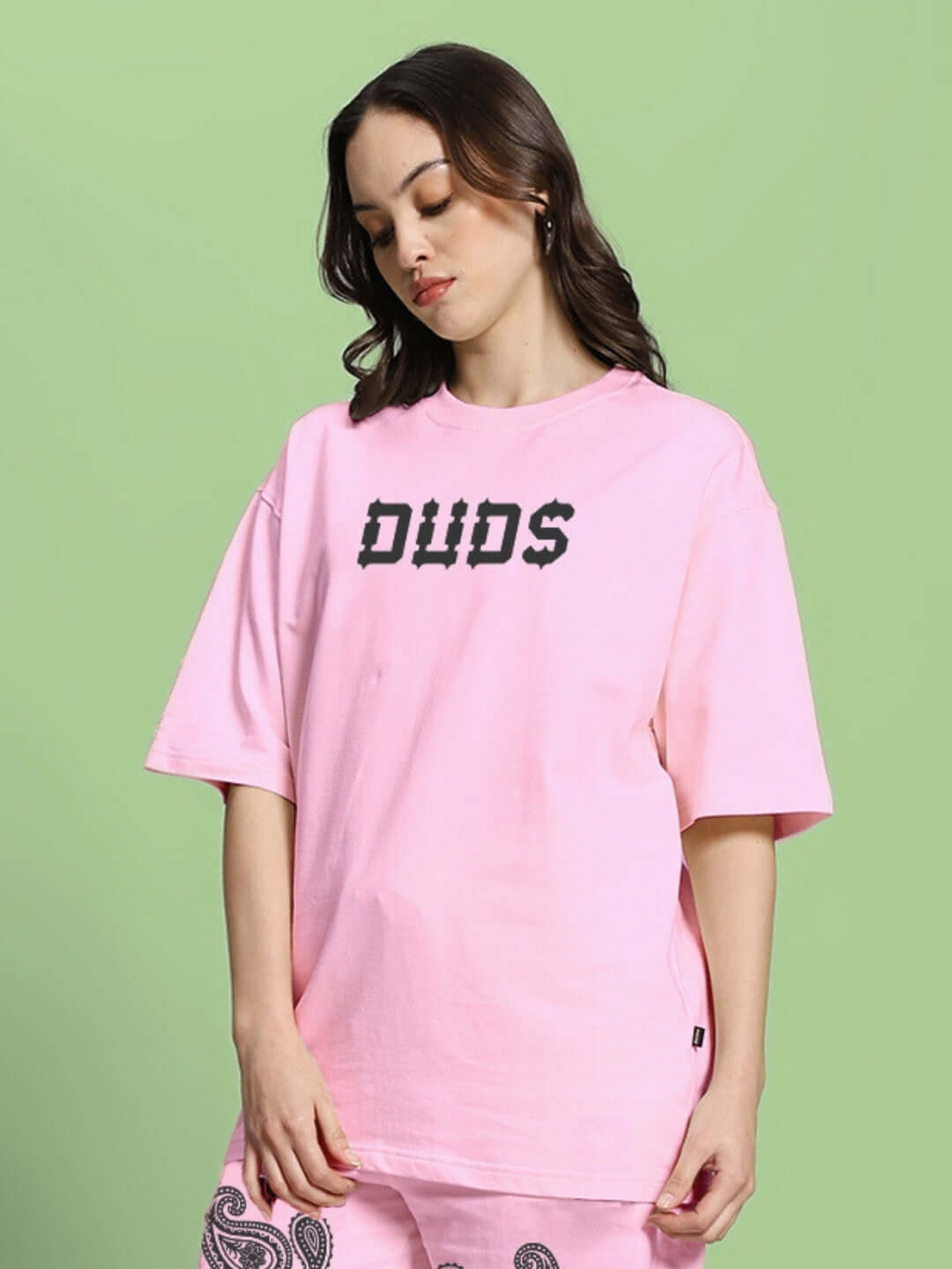 Model wearing pink oversized t-shirt with paisley print from WOMEN'S MESSI collection made of premium fabric, by Color By Colours.