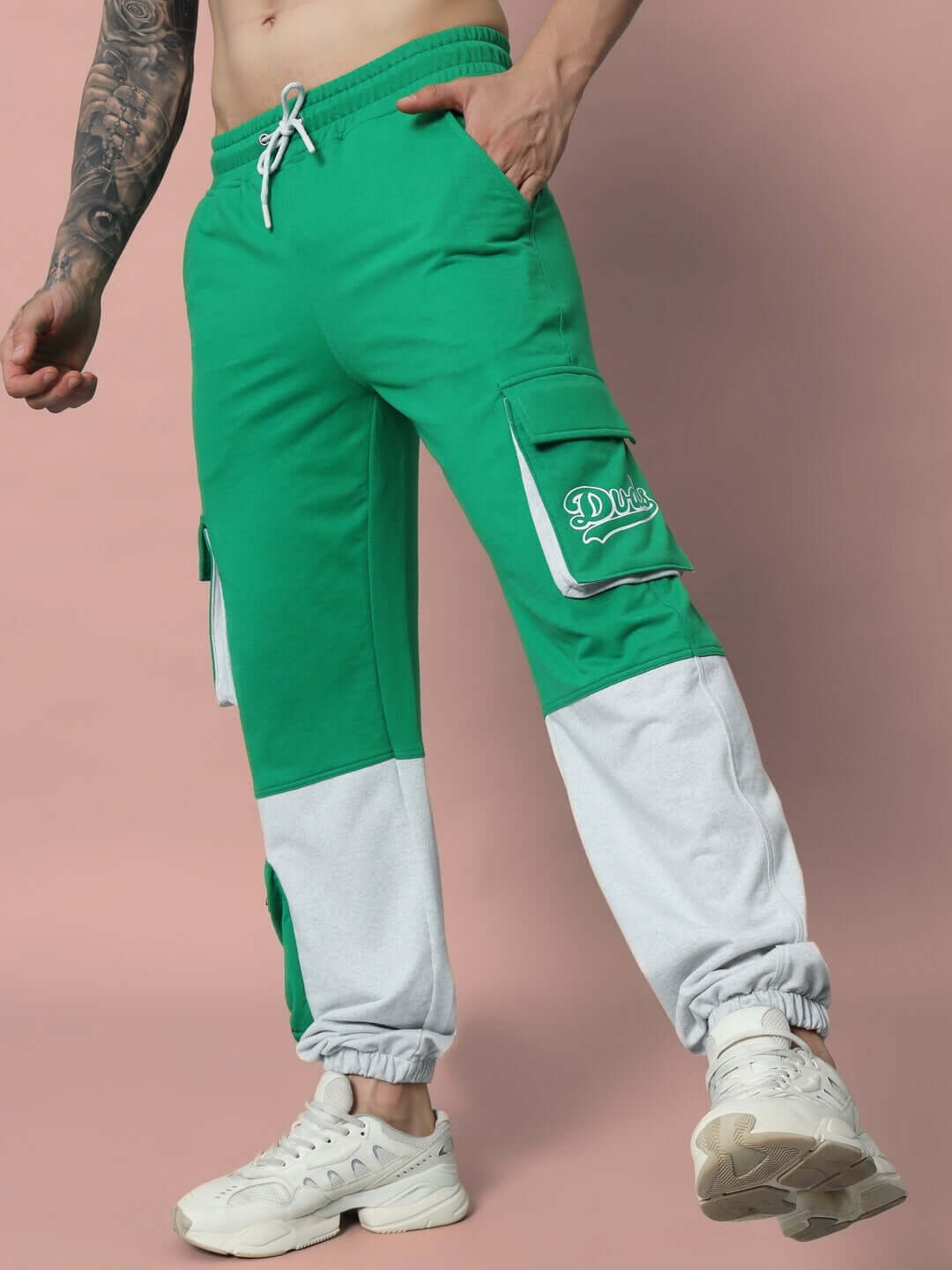 Model wearing SKYSCRAPER RELAXED FIT CARGO PANT GREEN with gray accents, showcasing casual fit and side pockets.