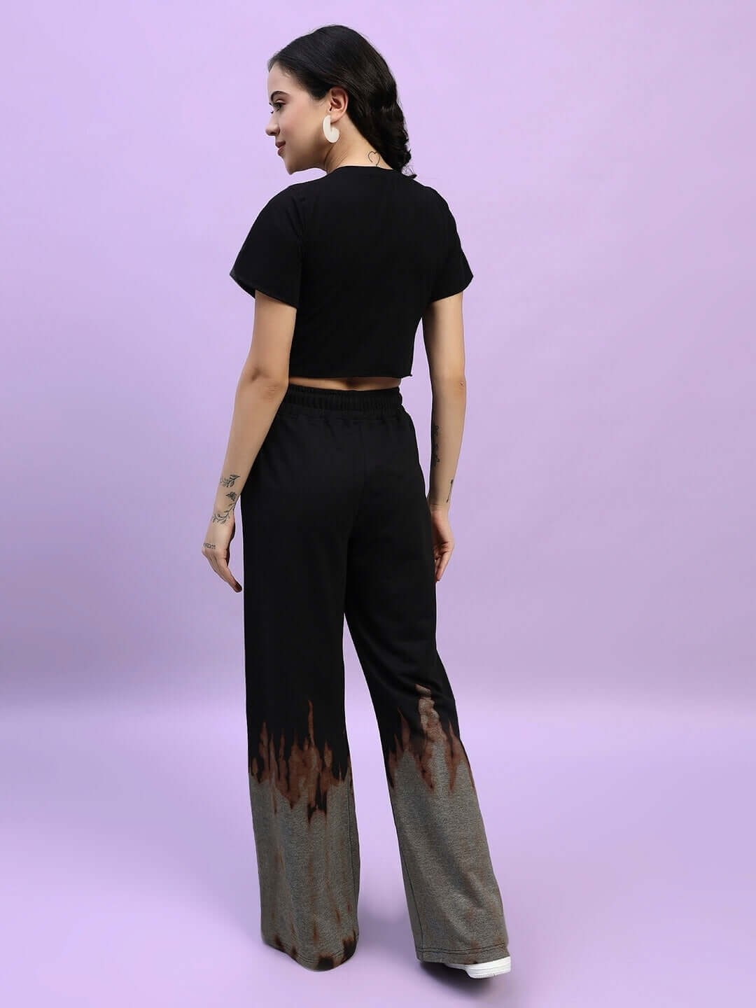 Model wearing Women's Fire Flame Baggy Tie-Dye Co-Ord Set in Black, featuring cotton fabric with bio-washed finish and unique flame design.