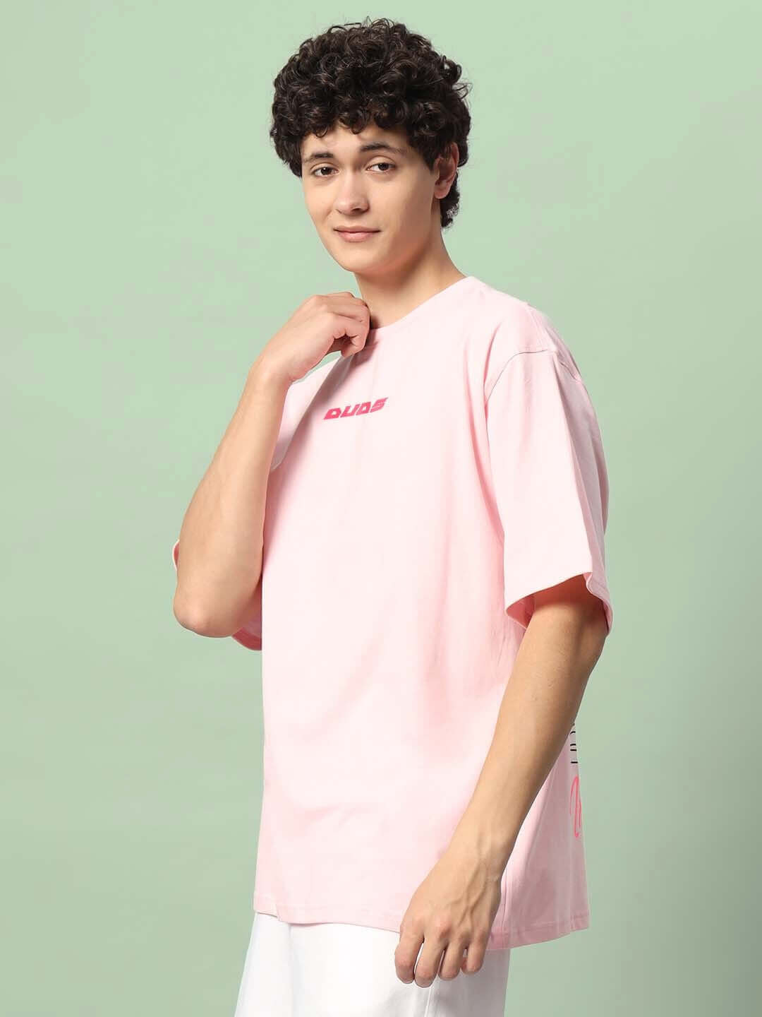 ILLUSION OVER-SIZED T-SHIRT PINK worn by model in casual style, showcasing relaxed fit and pastel color.