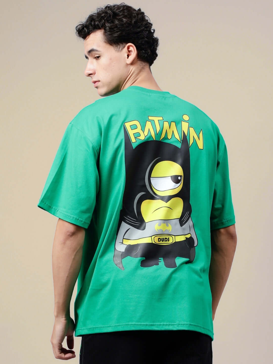 Man wearing BATMIN OVER-SIZED T-SHIRT GREEN with cartoon design on the back