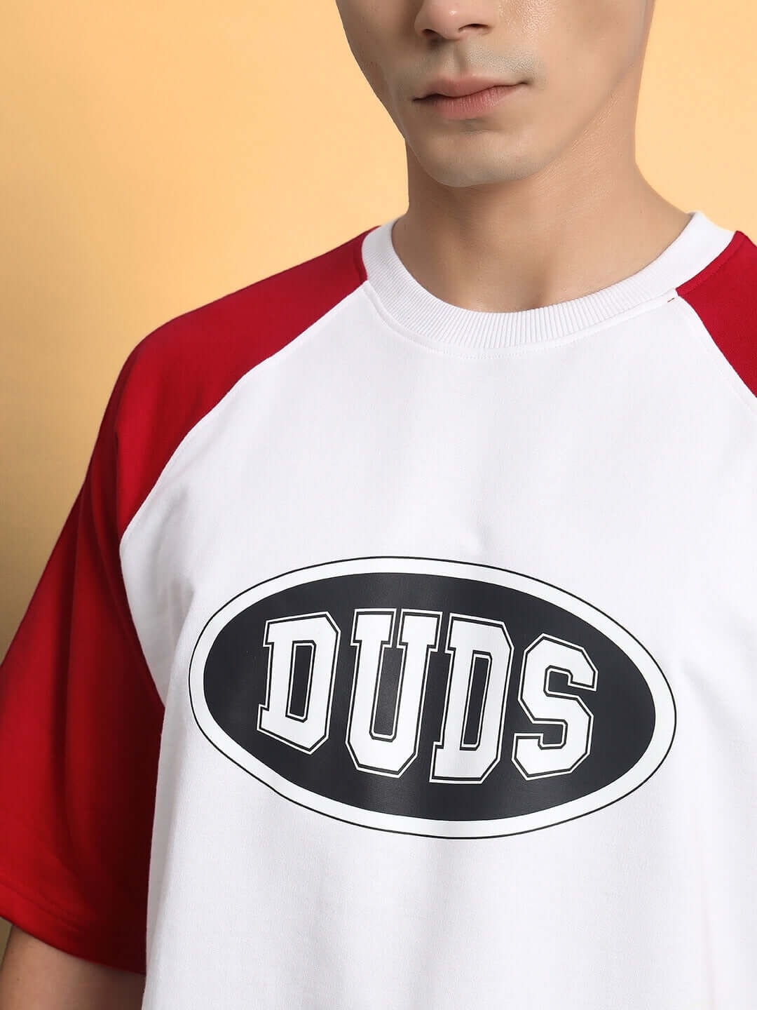 NEVER GIVE UP OVERSIZED T-SHIRT RED featuring premium cotton fabric with red sleeves and DUDS logo, perfect for casual wear.