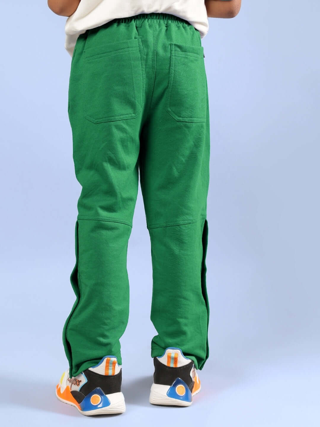 Child wearing green pants from ADONIS CO-ORD set, featuring an off white-green design, showcasing the back view.