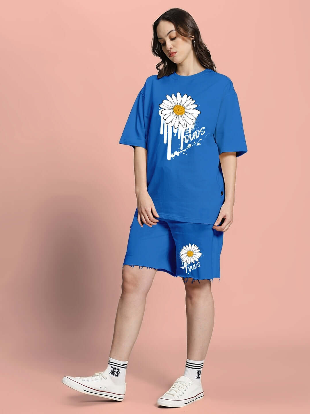 Model wearing blue oversized t-shirt with floral print, made from premium cotton blend. Comfortable and stylish women's fashion.