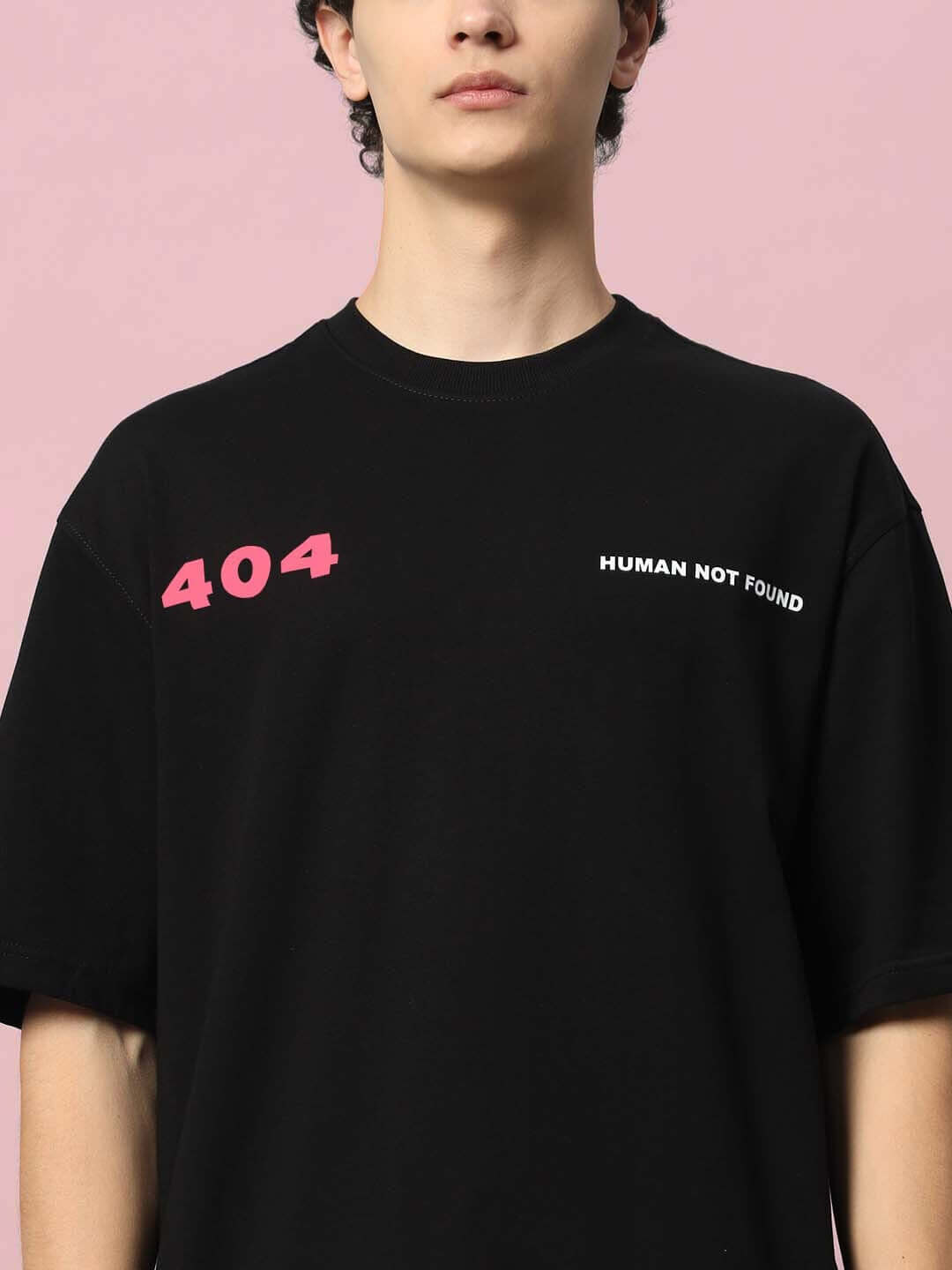 Model wearing 404 ERROR OVER-SIZED T-SHIRT BLACK with '404 Human Not Found' print.