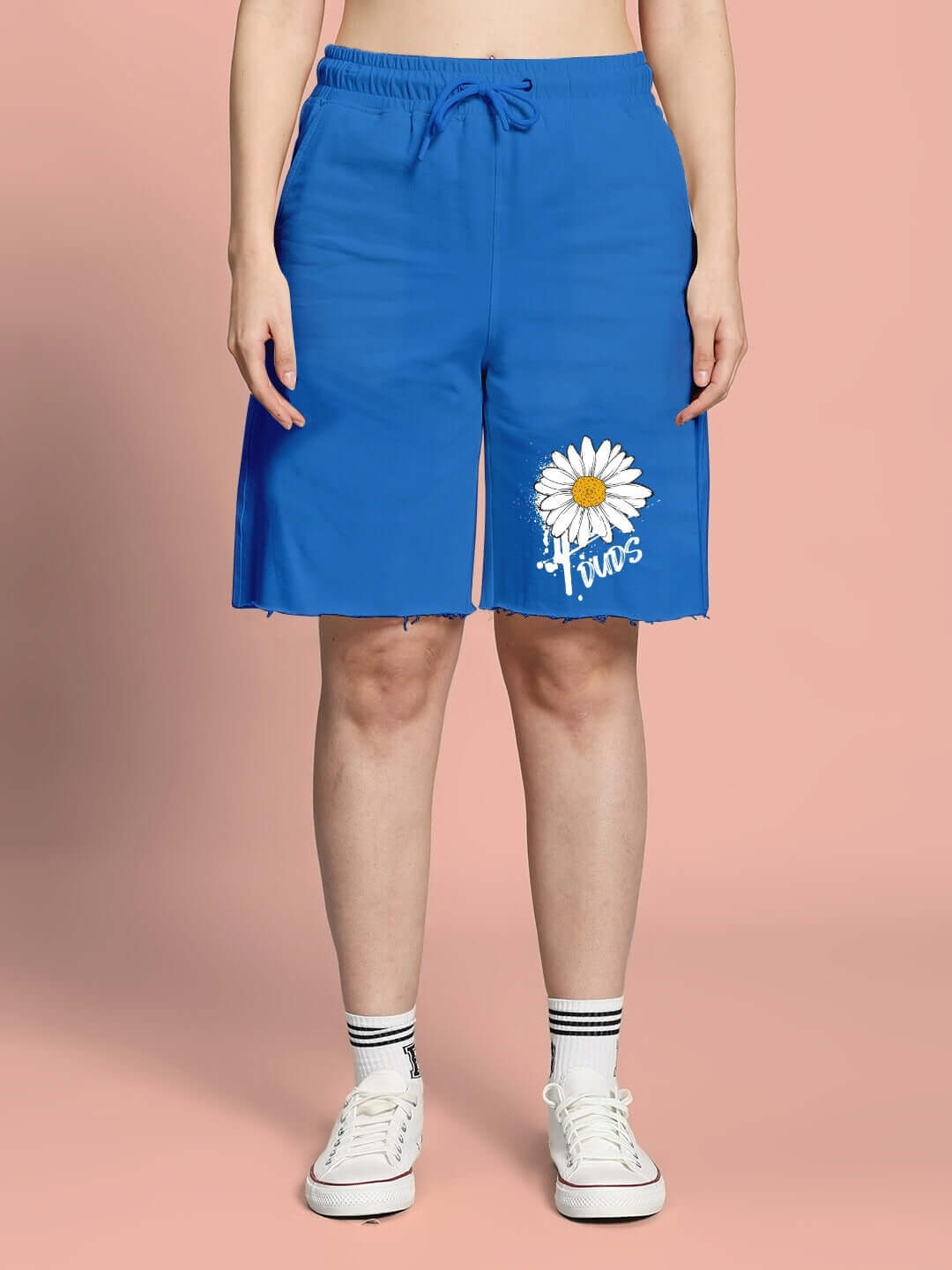 Women's blue Helianthus regular fit shorts with white daisy design, customizable size option, shown on model with white sneakers.