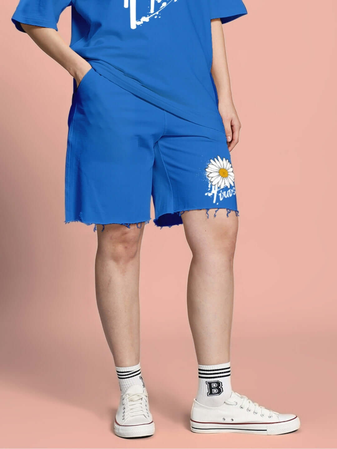 Model wearing Women's Helianthus Regular Fit Blue Shorts with sunflower design, paired with a matching blue top and white sneakers.
